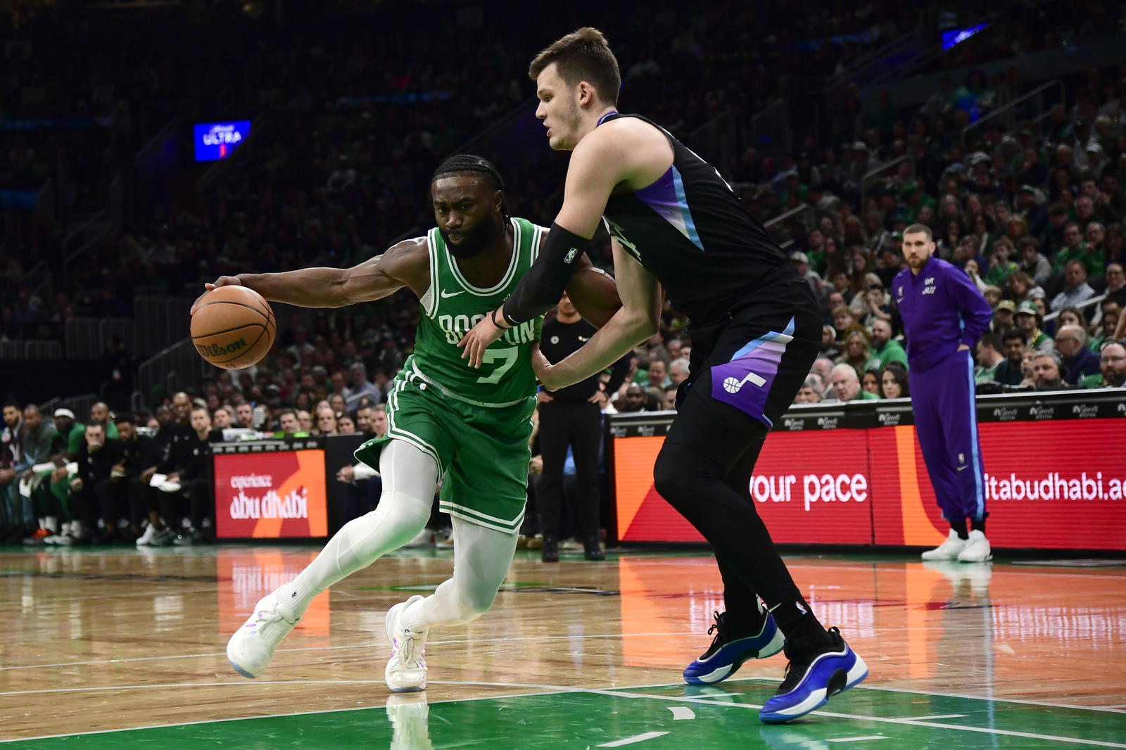 Mar 10, 2025; Boston, Massachusetts, USA; Boston Celtics guard Jaylen Brown (7) controls the ball while Utah Jazz center Walker Kessler (24) defends during the first half at TD Garden. (Bob DeChiara/Imagn Images)