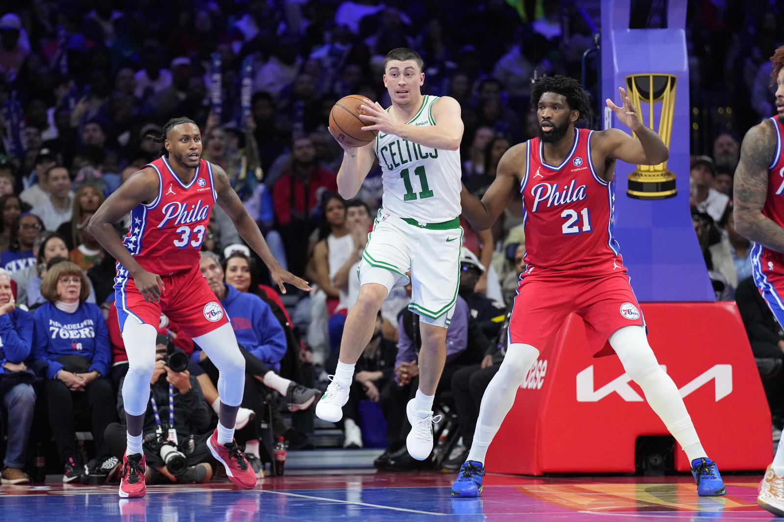 Oct 31, 2025; Philadelphia, Pennsylvania, USA; Boston Celtics guard Payton Pritchard (11) passes the ball against Philadelphia 76ers center Joel Embiid (21) in the third quarter at Xfinity Mobile Arena. (Kyle Ross/Imagn Images)