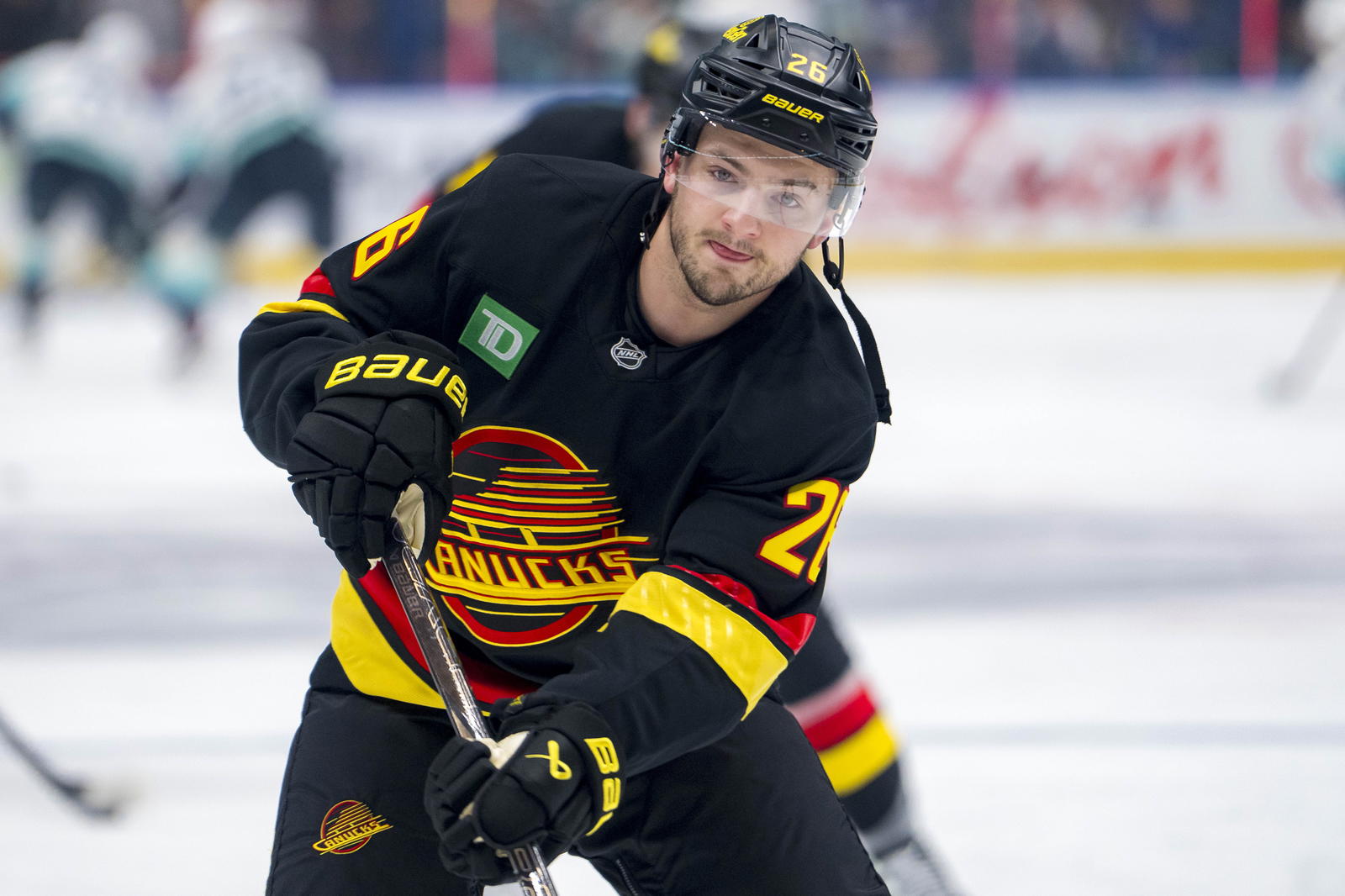 Dec 28, 2024; Vancouver, British Columbia, CAN; Vancouver Canucks defenseman Erik Brannstrom (26) shoots during warm up prior to a game against the Seattle Kraken at Rogers Arena. Mandatory Credit: Bob Frid-Imagn Images