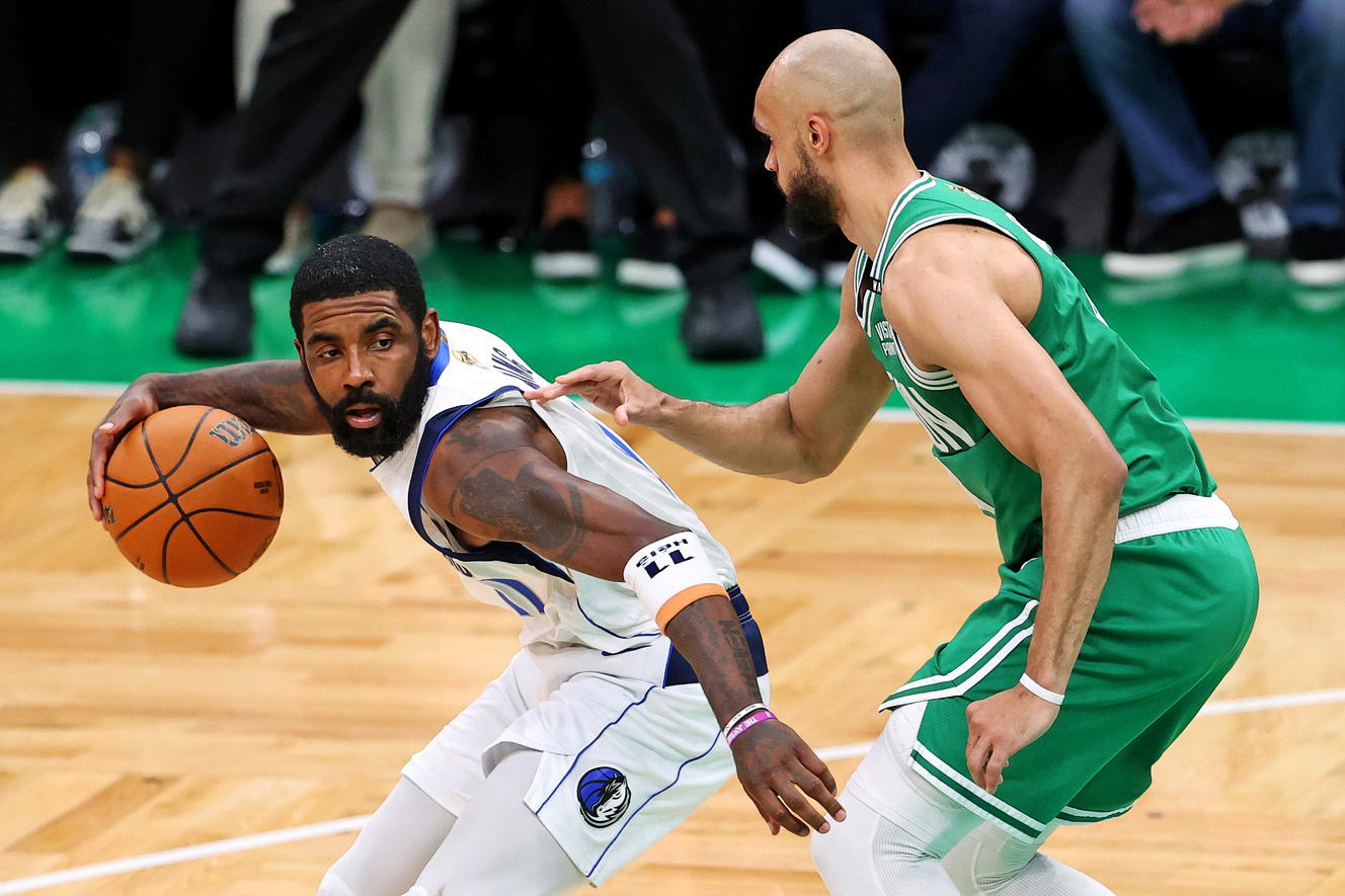 Jun 17, 2024; Boston, Massachusetts, USA; Dallas Mavericks guard Kyrie Irving (11) handles the ball against Boston Celtics guard Derrick White (9) in game five of the 2024 NBA Finals at TD Garden. (Peter Casey/Imagn Images)