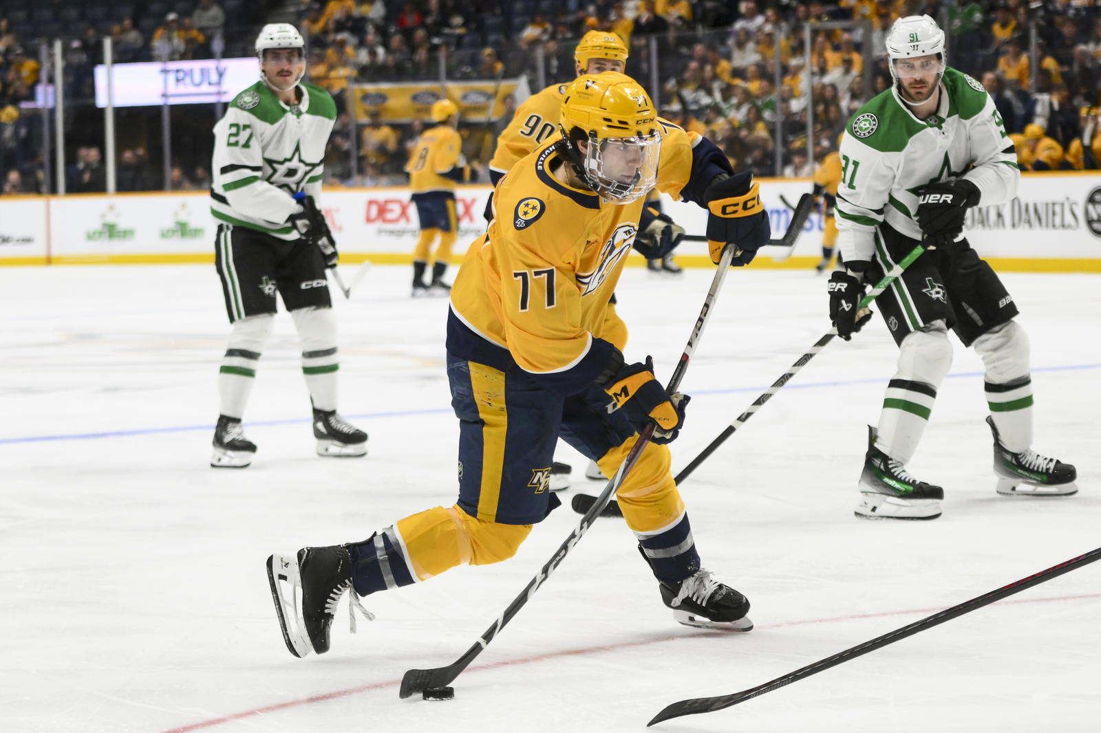 Apr 16, 2025; Nashville, Tennessee, USA; Nashville Predators right wing Luke Evangelista (77) takes a shot on goal against the Dallas Stars during the third period at Bridgestone Arena. Mandatory Credit: Steve Roberts-Imagn Images