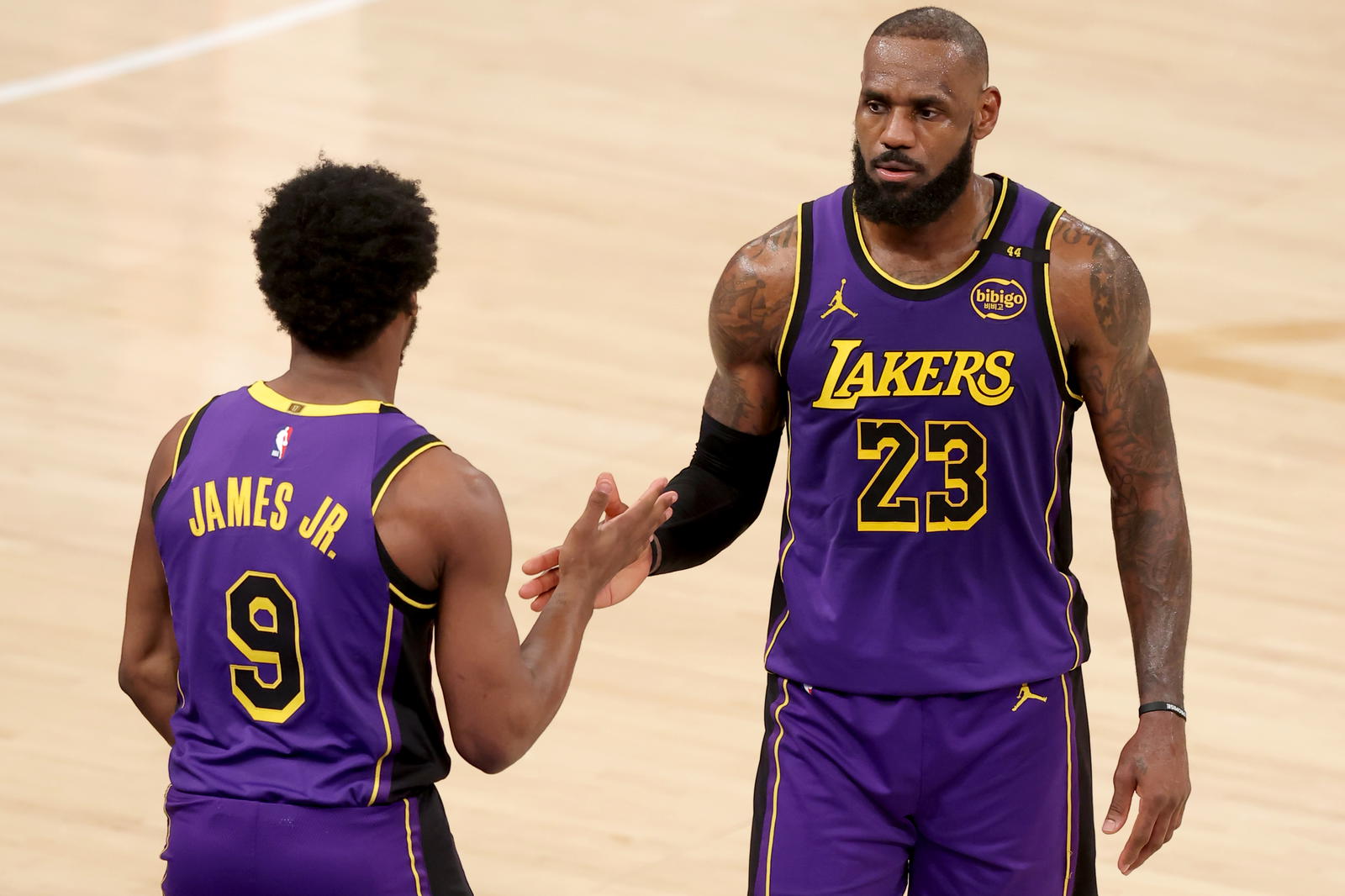 Los Angeles Lakers guard Bronny James (9) checks in for forward LeBron James (23) during the fourth quarter against the New York Knicks at Madison Square Garden. Brad Penner-Imagn Images