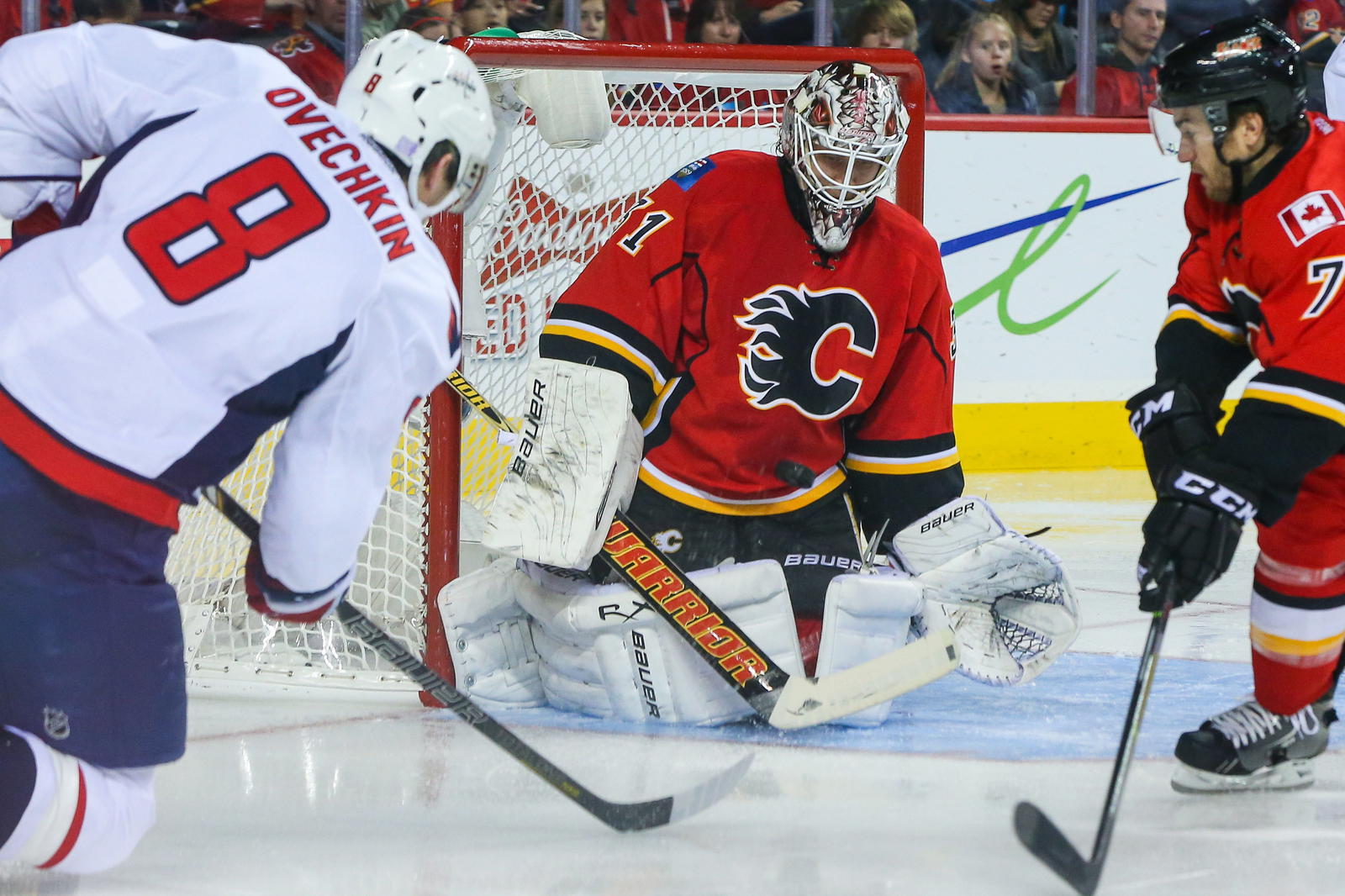 Oct 26, 2013; Calgary, Alberta, CAN; Calgary Flames goalie Karri Ramo (31) makes a save against a shot from Washington Capitals right wing Alex Ovechkin (8) as Calgary Flames defenseman T.J. Brodie (7) defends during the second period at Scotiabank Saddledome. Mandatory Credit: Sergei Belski-Imagn Images
