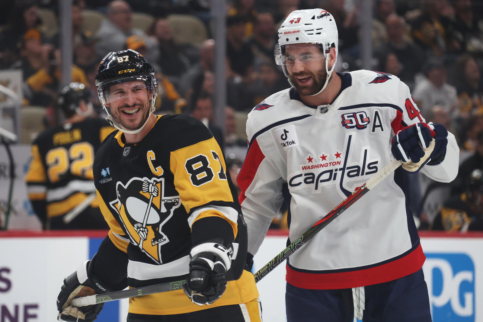 Apr 17, 2025; Pittsburgh, Pennsylvania, USA; Washington Capitals right wing Tom Wilson (43) and Pittsburgh Penguins center Sidney Crosby (87) share a laugh during the first period at PPG Paints Arena. (Charles LeClaire-Imagn Images)