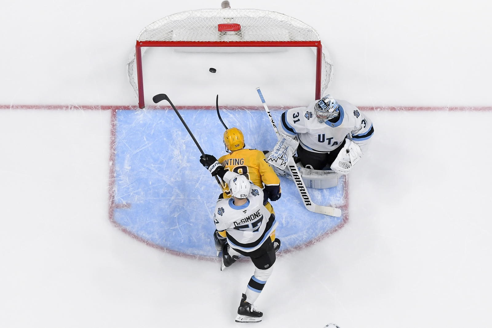 Apr 14, 2025; Nashville, Tennessee, USA; Nashville Predators left wing Michael Bunting (58) scores past Utah Hockey Club goaltender Matt Villalta (31) during the second period at Bridgestone Arena. Mandatory Credit: Steve Roberts-Imagn Images