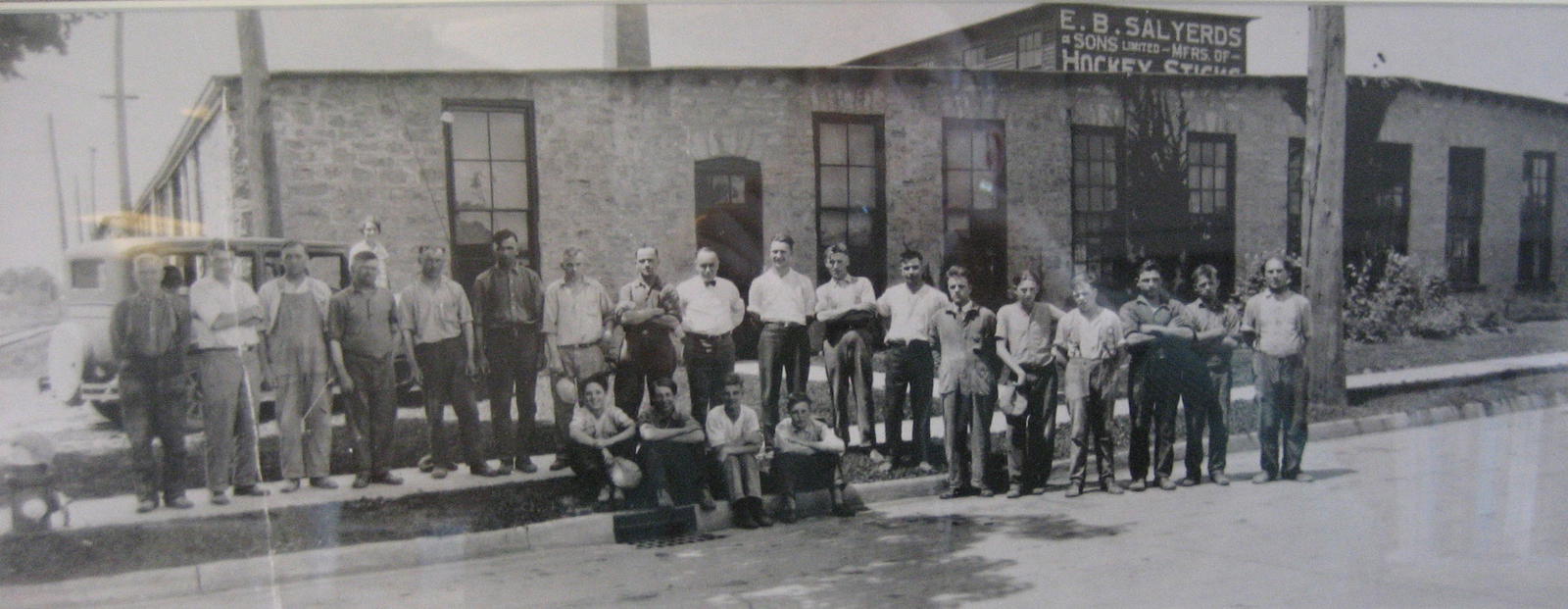 E.B. Salyerds and Sons hockey stick in factory in Preston, Ontario (now part of Cambridge, Ontario). E.B. Salyerds is believed to be the gentleman wearing a white shirt and black bow tie, standing roughly in the middle. (Courtesy of the City of Cambridge Archives)