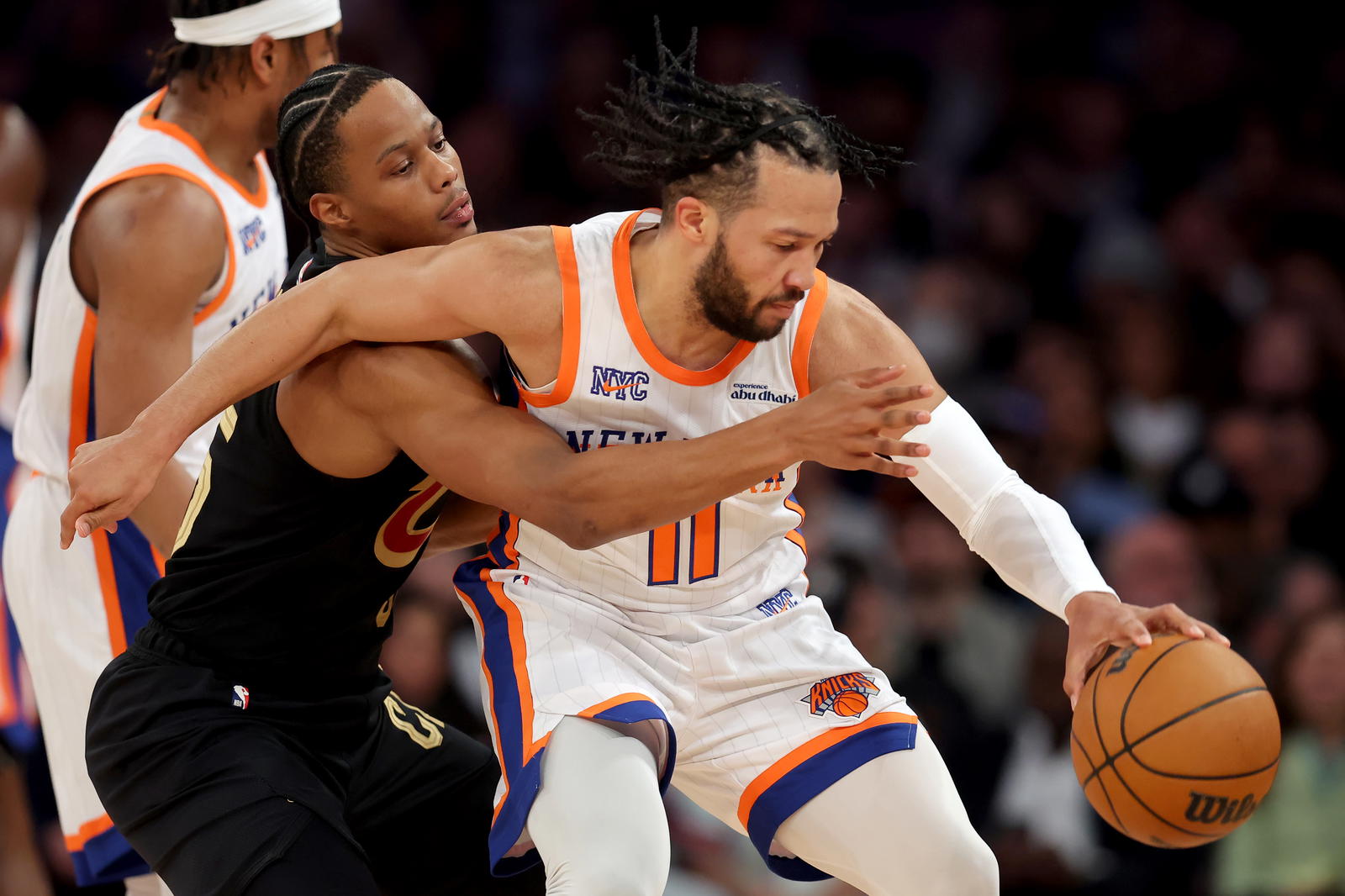 Apr 11, 2025; New York, New York, USA; Cleveland Cavaliers forward Isaac Okoro (35) reaches for the ball against New York Knicks guard Jalen Brunson (11) during the first quarter at Madison Square Garden. Mandatory Credit: Brad Penner-Imagn Images