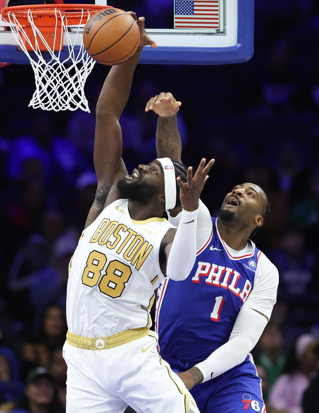 Nov 11, 2025; Philadelphia, Pennsylvania, USA; Boston Celtics center Neemias Queta (88) rebounds the ball in front of Philadelphia 76ers center Andre Drummond (1) during the first quarter at Xfinity Mobile Arena. (Bill Streicher/Imagn Images)