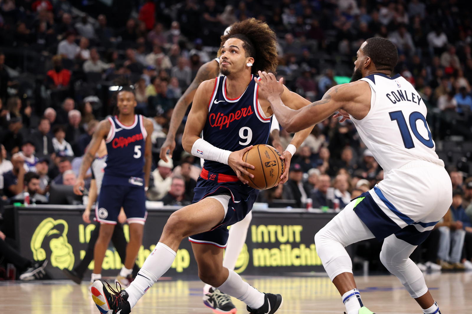 Dec 4, 2024; Inglewood, California, USA; Los Angeles Clippers guard Trentyn Flowers (9) drives to the basket against Minnesota Timberwolves guard Mike Conley (10) during the fourth quarter at Intuit Dome. Mandatory Credit: Kiyoshi Mio-Imagn Images