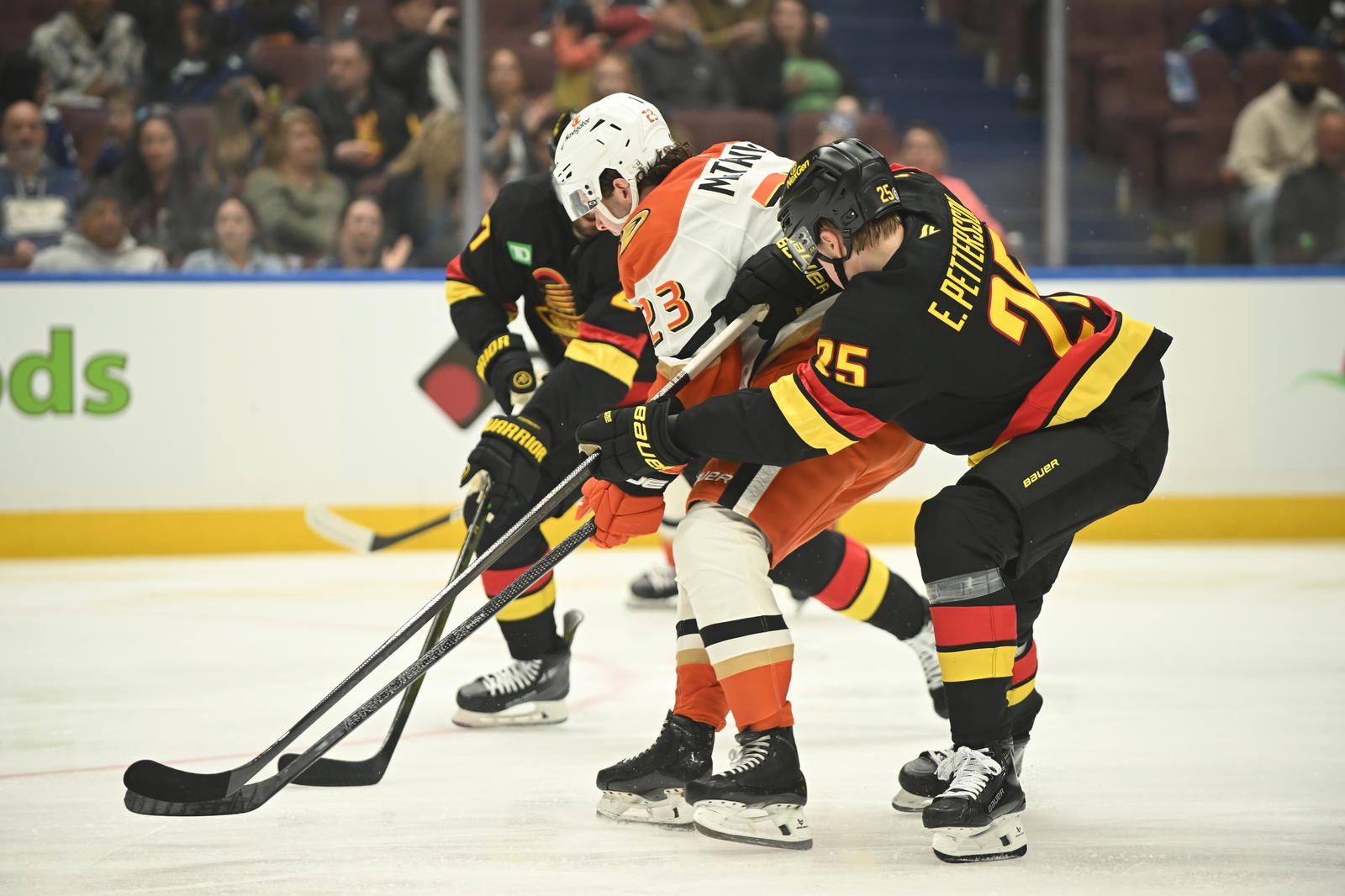 Apr 5, 2025; Vancouver, British Columbia, CAN; Vancouver Canucks defenseman Elias Pettersson (25) defends against Anaheim Ducks forward Mason McTavish (23) during the first period at Rogers Arena. Mandatory Credit: Anne-Marie Sorvin-Imagn Images