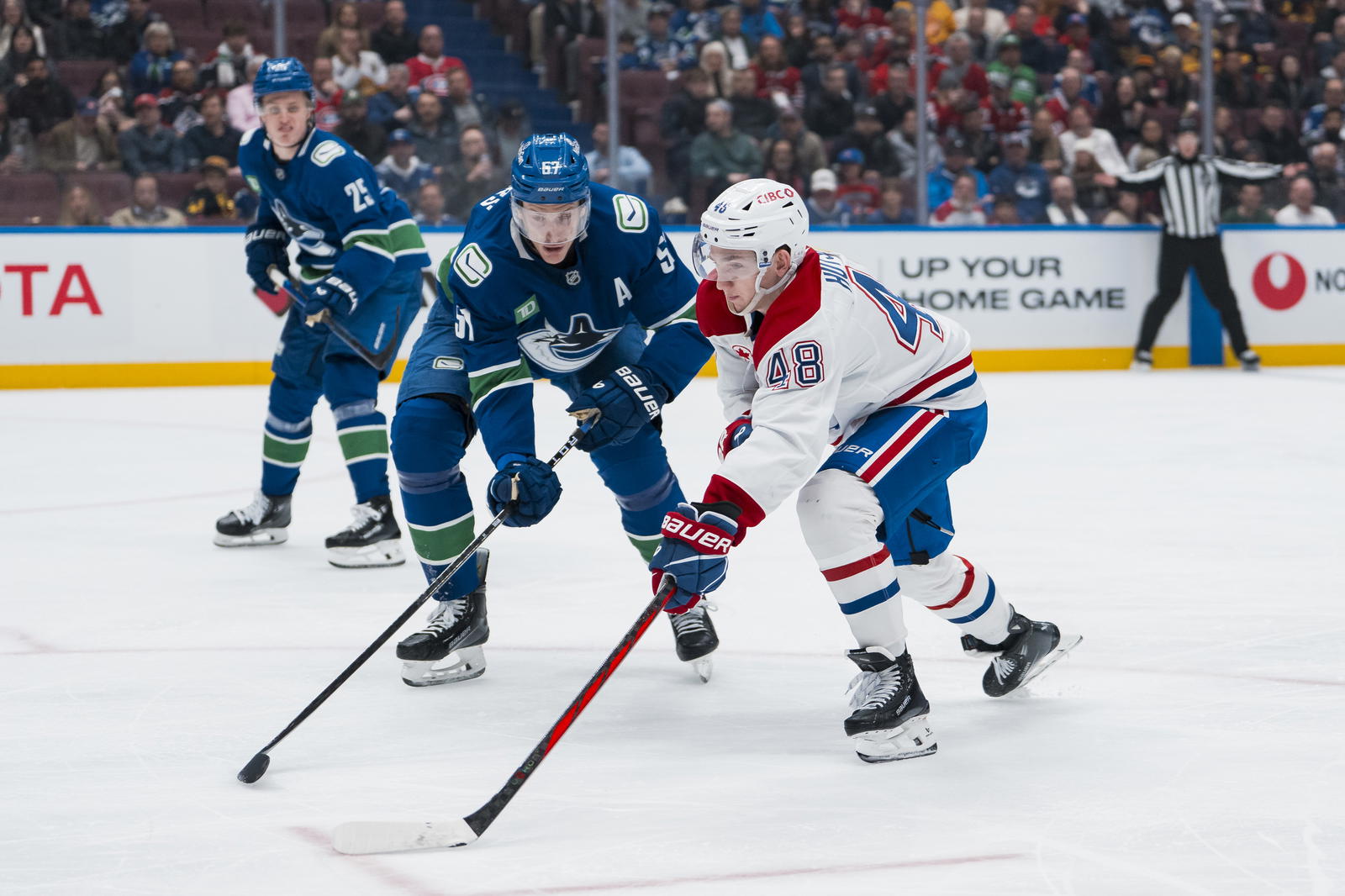 Mar 11, 2025; Vancouver, British Columbia, CAN; Montreal Canadiens defenseman Lane Hutson (48) drives past Vancouver Canucks defenseman Tyler Myers (57) in the third period at Rogers Arena. Mandatory Credit: Bob Frid-Imagn Images