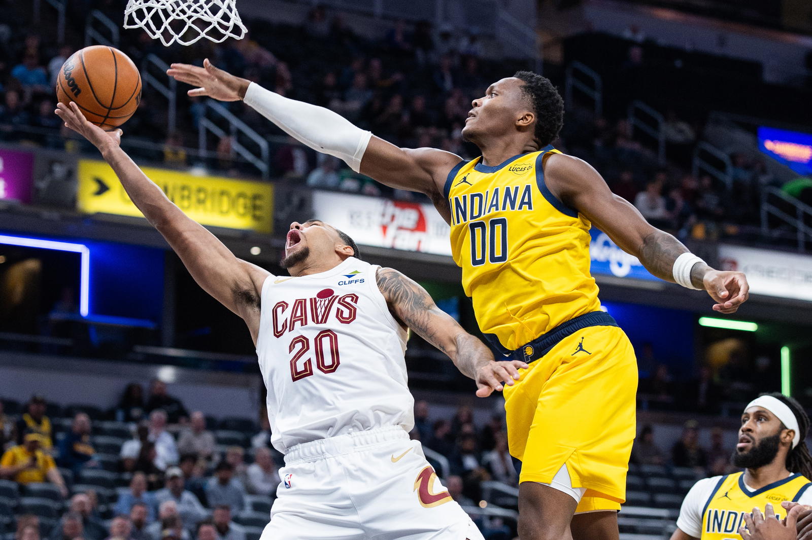 Dec 1, 2025; Indianapolis, Indiana, USA; Cleveland Cavaliers guard Jaylon Tyson (20) shoots the ball while Indiana Pacers guard Bennedict Mathurin (00) defends in the first half at Gainbridge Fieldhouse. Mandatory Credit: Trevor Ruszkowski-Imagn Images