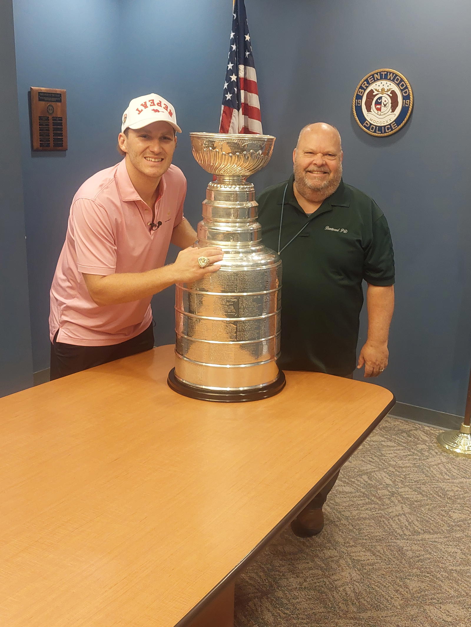 Florida Panthers and St. Louis-raised forward Matthew Tkachuk (left) poses with the Stanley Cup with Brentwood Police Department's&nbsp;senior law enforcement analyst Thomas J. Bottini.
