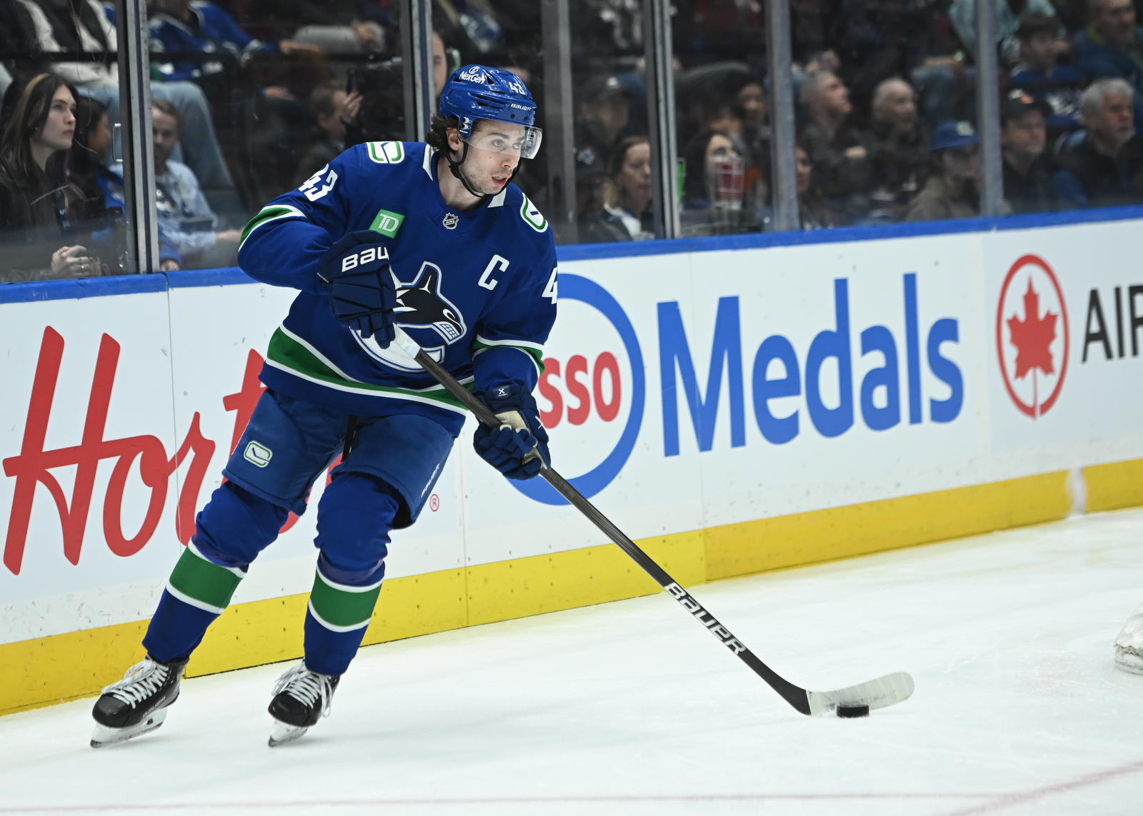 Apr 2, 2025; Vancouver, British Columbia, CAN; Vancouver Canucks defenseman Quinn Hughes (43) skates with puck against the Seattle Kraken during the first period at Rogers Arena. Mandatory Credit: Simon Fearn-Imagn Images