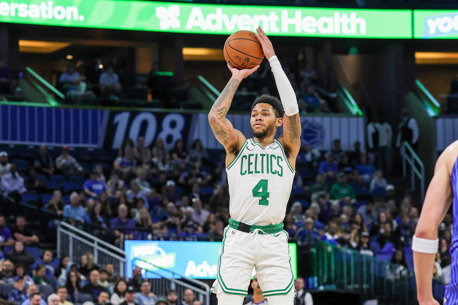Nov 9, 2025; Orlando, Florida, USA; Boston Celtics guard Anfernee Simons (4) shoots a three point basket during the second quarter against the Orlando Magic at Kia Center. (Mike Watters/Imagn Images)
