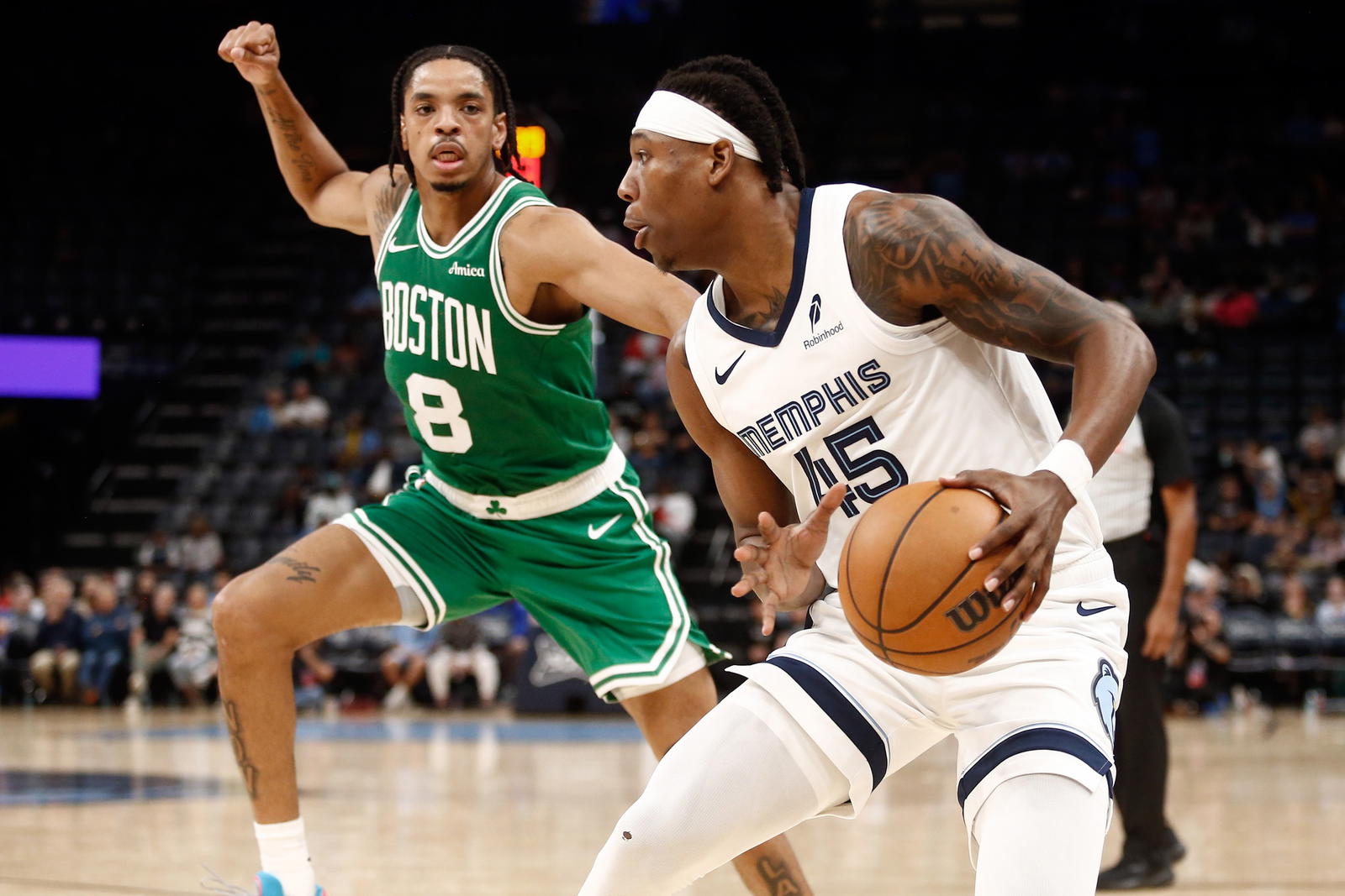 Oct 8, 2025; Memphis, Tennessee, USA; Memphis Grizzlies forward GG Jackson II (45) handles the ball as Boston Celtics forward Josh Minott (8) defends during the fourth quarter at FedExForum. (Petre Thomas/Imagn Images)
