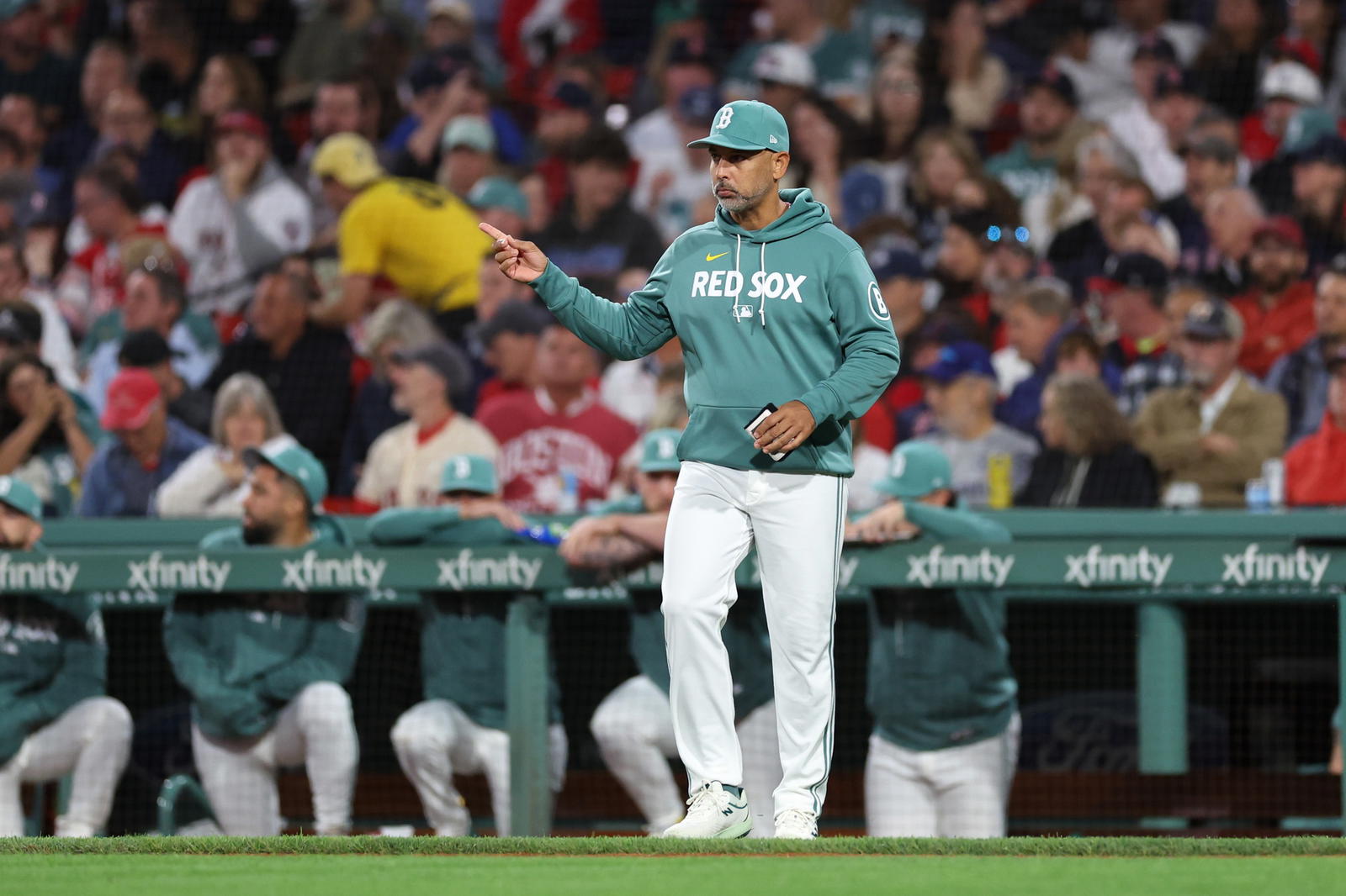 Sep 12, 2025; Boston, Massachusetts, USA; Boston Red Sox manager Alex Cora (13) signals to the bullpen during the sixth inning against the New York Yankees at Fenway Park. (Paul Rutherford/Imagn Images)