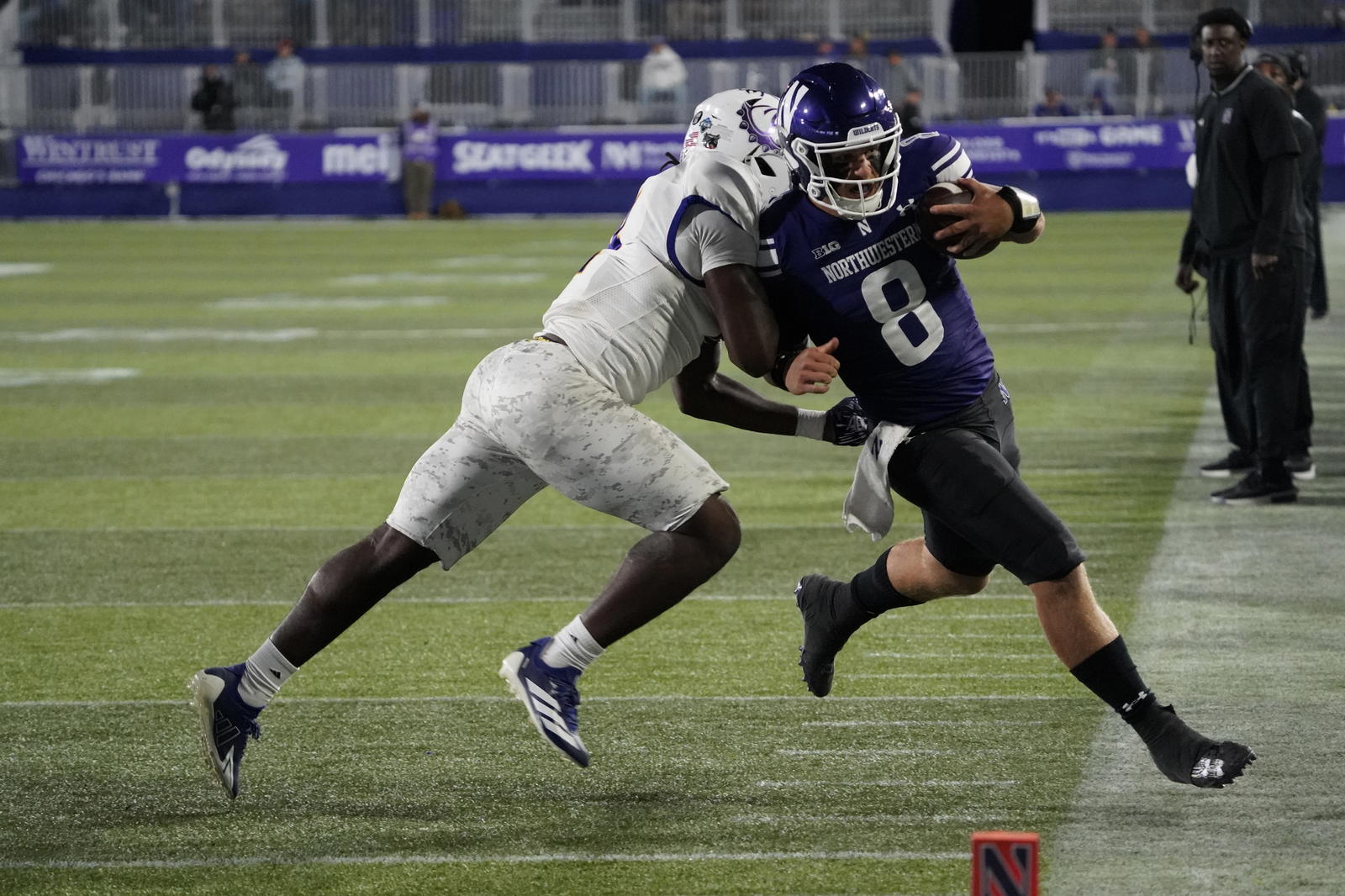 Sep 5, 2025; Evanston, Illinois, USA; Western Illinois Leathernecks defensive back Malini Ti'a (33) defends Northwestern Wildcats quarterback Preston Stone (8) during the second half at Northwestern Medicine Field at Martin Stadium. Mandatory Credit: David Banks-Imagn Images