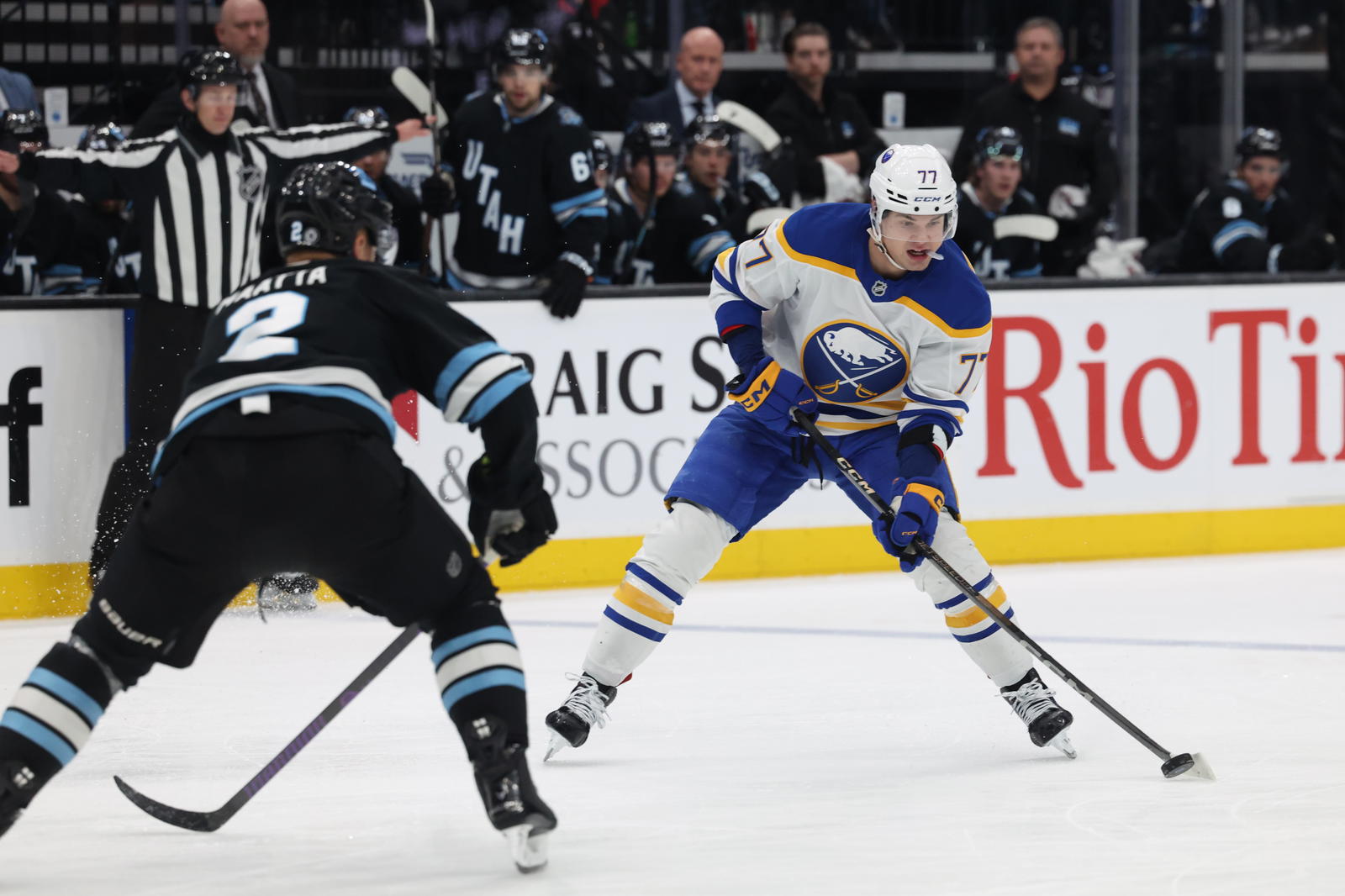 Mar 20, 2025; Salt Lake City, Utah, USA; Buffalo Sabres right wing JJ Peterka (77) moves the puck against Utah Hockey Club defenseman Olli Määttä (2) during the third period at Delta Center. Mandatory Credit: Rob Gray-Imagn Images