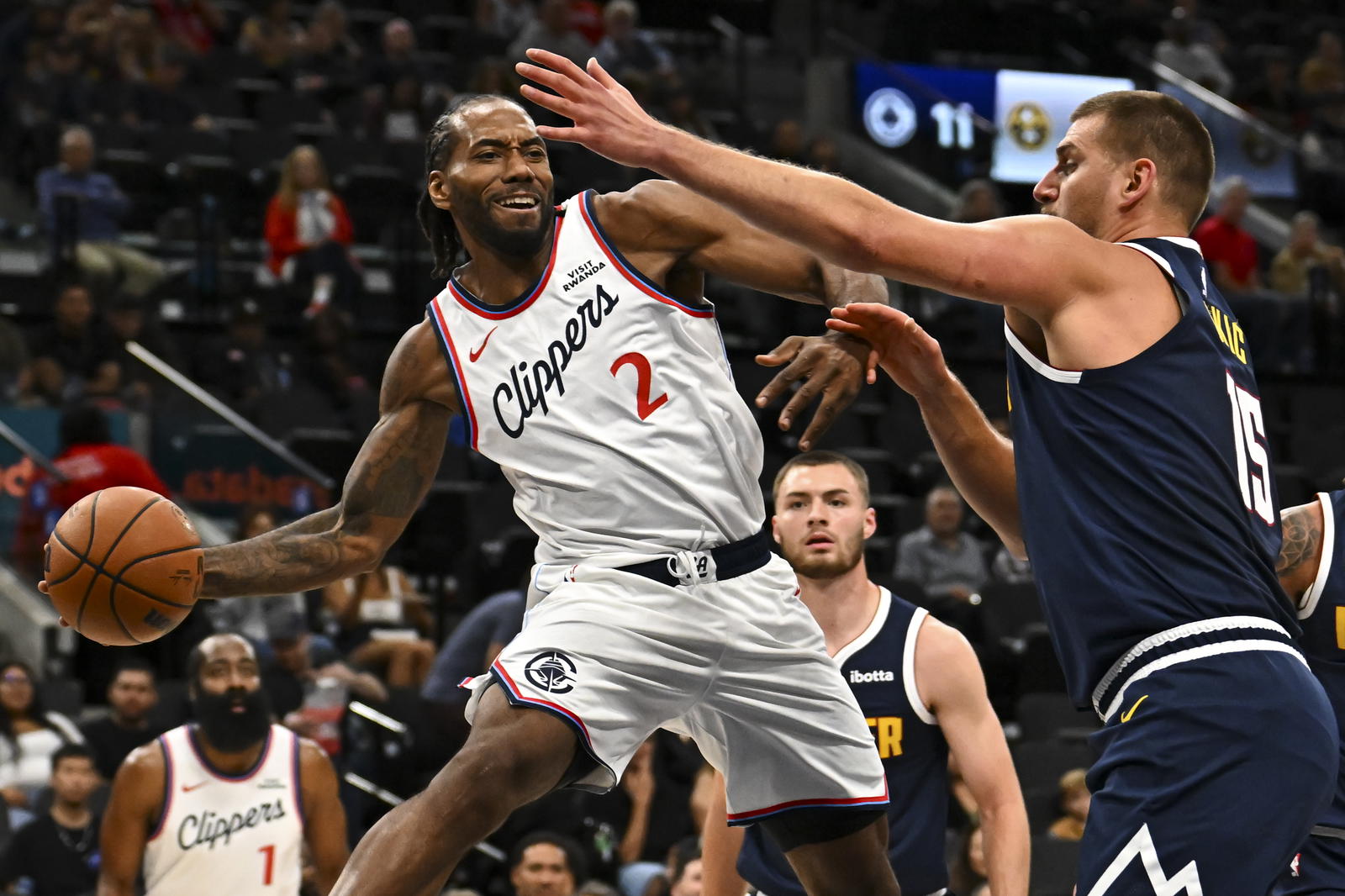 Los Angeles Clippers forward Kawhi Leonard (2) passes the ball against Denver Nuggets center Nikola Jokić (15) during the first quarter at Intuit Dome. Mandatory Credit: Jonathan Hui-Imagn Images