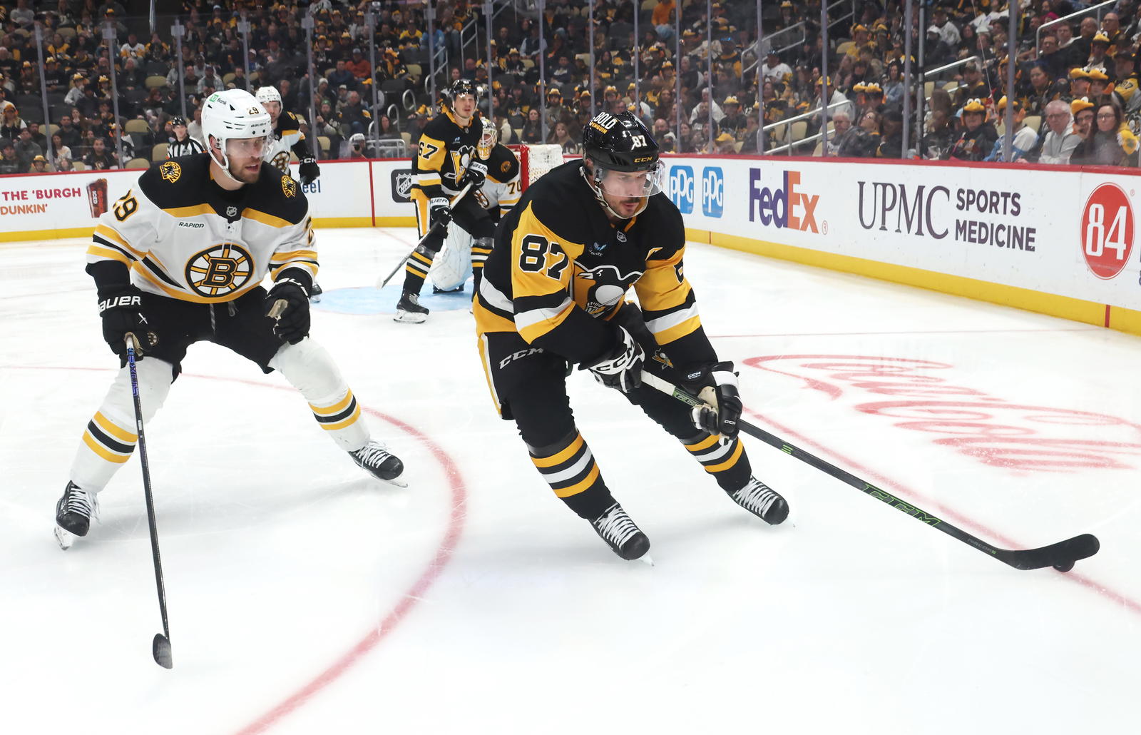 Apr 13, 2025; Pittsburgh, Pennsylvania, USA; Pittsburgh Penguins center Sidney Crosby (87) skates with the puck against Boston Bruins defenseman Parker Wotherspoon (29) during the third period at PPG Paints Arena. Mandatory Credit: Charles LeClaire-Imagn Images