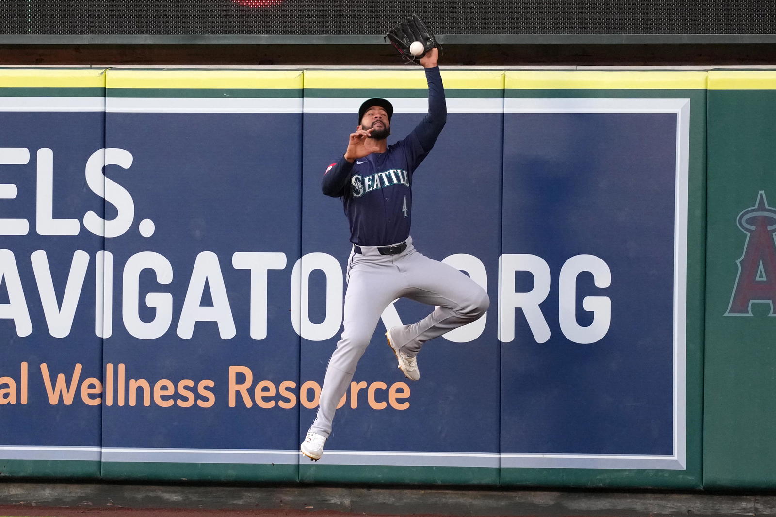 Seattle Mariners center fielder Leody Taveras (4) is unable to catch a fly ball double by Los Angeles Angels left fielder Taylor Ward (not pictured) in the third inning at Angel Stadium.&nbsp; Kirby Lee-Imagn Images