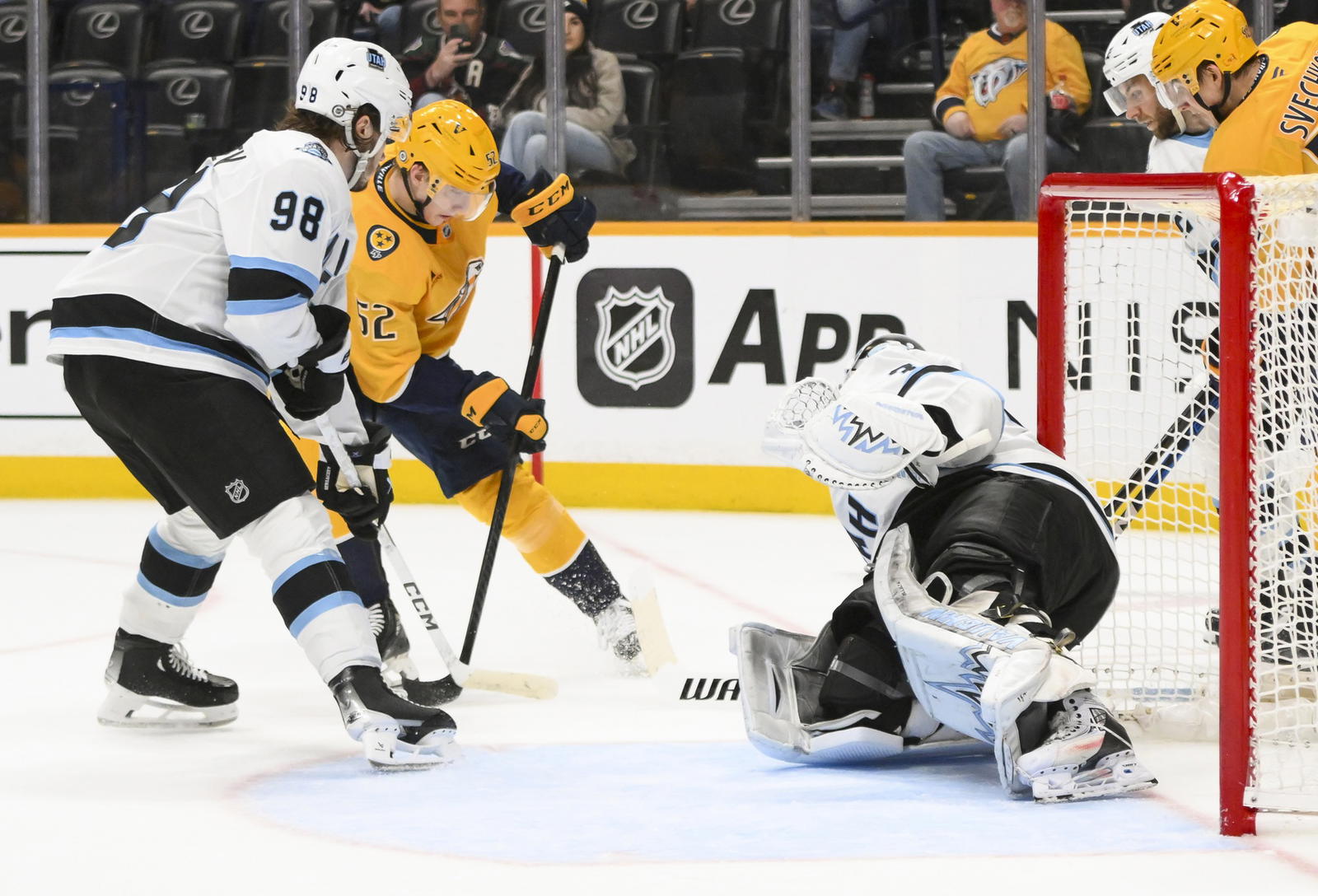 Apr 14, 2025; Nashville, Tennessee, USA; Utah Hockey Club goaltender Matt Villalta (31) blocks a shot by Nashville Predators right wing Matthew Wood (52) during the third period at Bridgestone Arena. Steve Roberts-Imagn Images