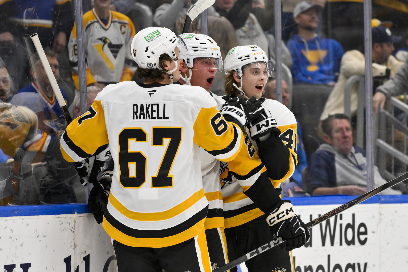 Apr 3, 2025; St. Louis, Missouri, USA; Pittsburgh Penguins right wing Rutger McGroarty (2) is congratulated by right wing Rickard Rakell (67) and right wing Ville Koivunen (41) after scoring his first NHL goal to tie the game against the St. Louis Blues during the third period at Enterprise Center. Mandatory Credit: Jeff Curry-Imagn Images