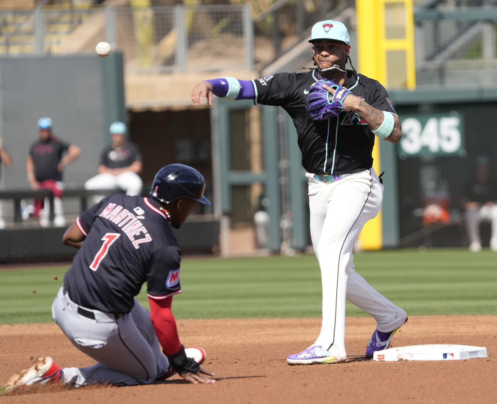 Arizona Diamondbacks second base Ketel Marte (4) throws to first after forcing out Cleveland Guardians outfielder Angel Martinez (1) during a spring training game at Salt River Fields on Feb. 24, 2025.