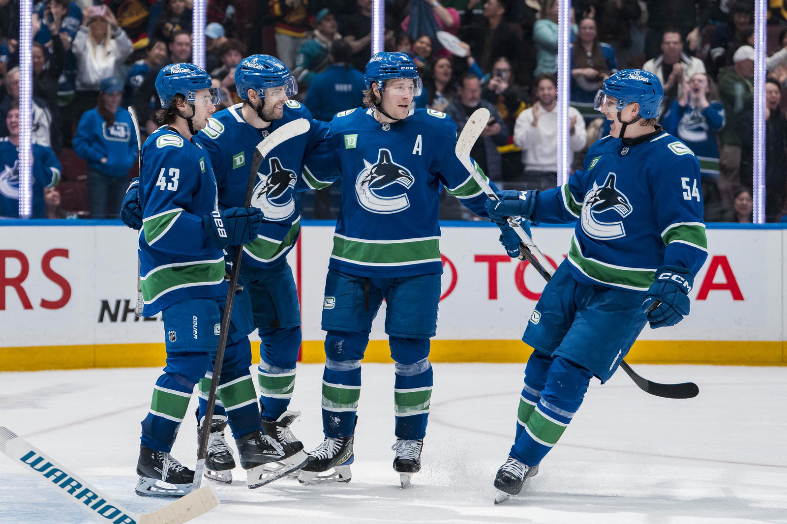 Apr 14, 2025; Vancouver, British Columbia, CAN; Vancouver Canucks forward Jake DeBrusk (74), forward Brock Boeser (6), defenseman Quinn Hughes (43) and forward Aatu Raty (54) celebrate DeBrusk’s goal against the San Jose Sharks in overtime at Rogers Arena. Mandatory Credit: Bob Frid-Imagn Images