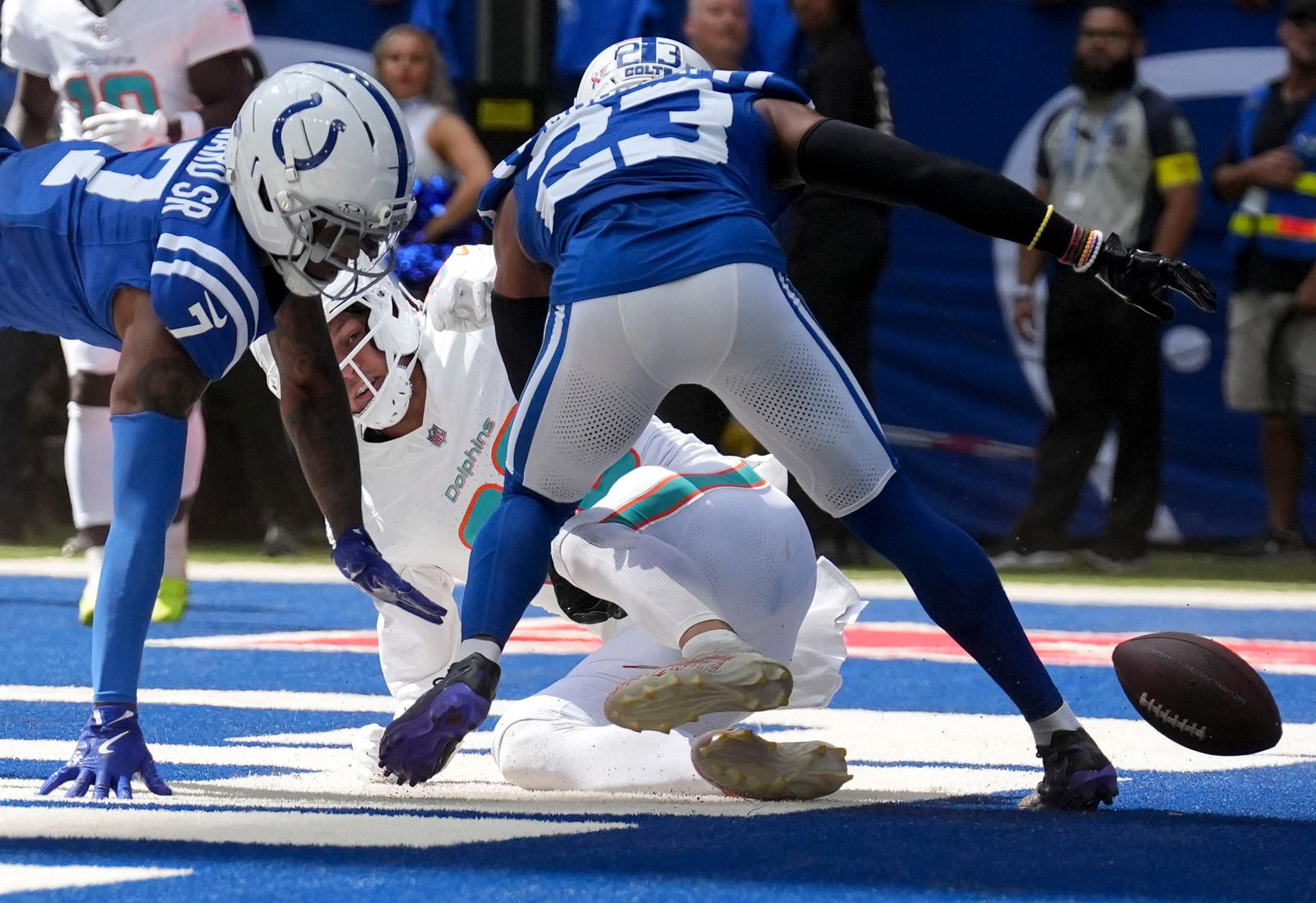 Indianapolis Colts cornerback Charvarius Ward Sr. (7) and cornerback Kenny Moore II (23) take down Miami Dolphins tight end Tanner Conner (80) as he misses a pass in the end zone during the second half of a game Sunday, Sept. 7, 2025, at Lucas Oil Stadium in Indianapolis. The Colts defeated the Dolphins 33-8. Mandatory Credit: Christine Tannous/IndyStar