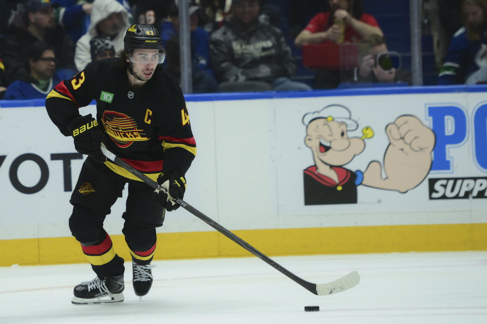Nov 23, 2025; Vancouver, British Columbia, CAN; Vancouver Canucks defenseman Quinn Hughes (43) skates with the puck during the second period against the Calgary Flames at Rogers Arena. Mandatory Credit: Simon Fearn-Imagn Images
