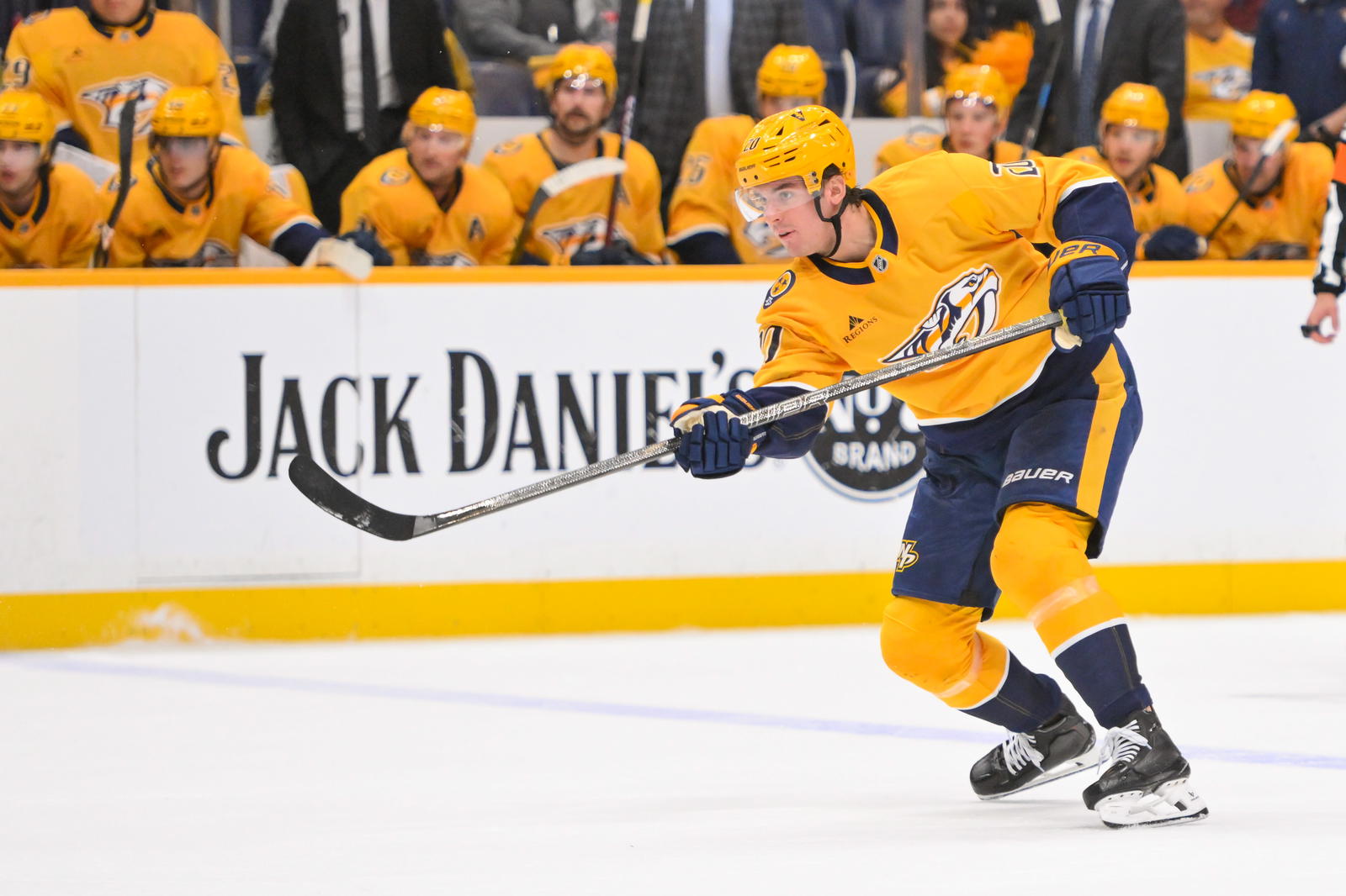 Mar 18, 2025; Nashville, Tennessee, USA; Nashville Predators defenseman Justin Barron (20) takes a shot on goal against the St. Louis Blues during the second period at Bridgestone Arena. Mandatory Credit: Steve Roberts-Imagn Images