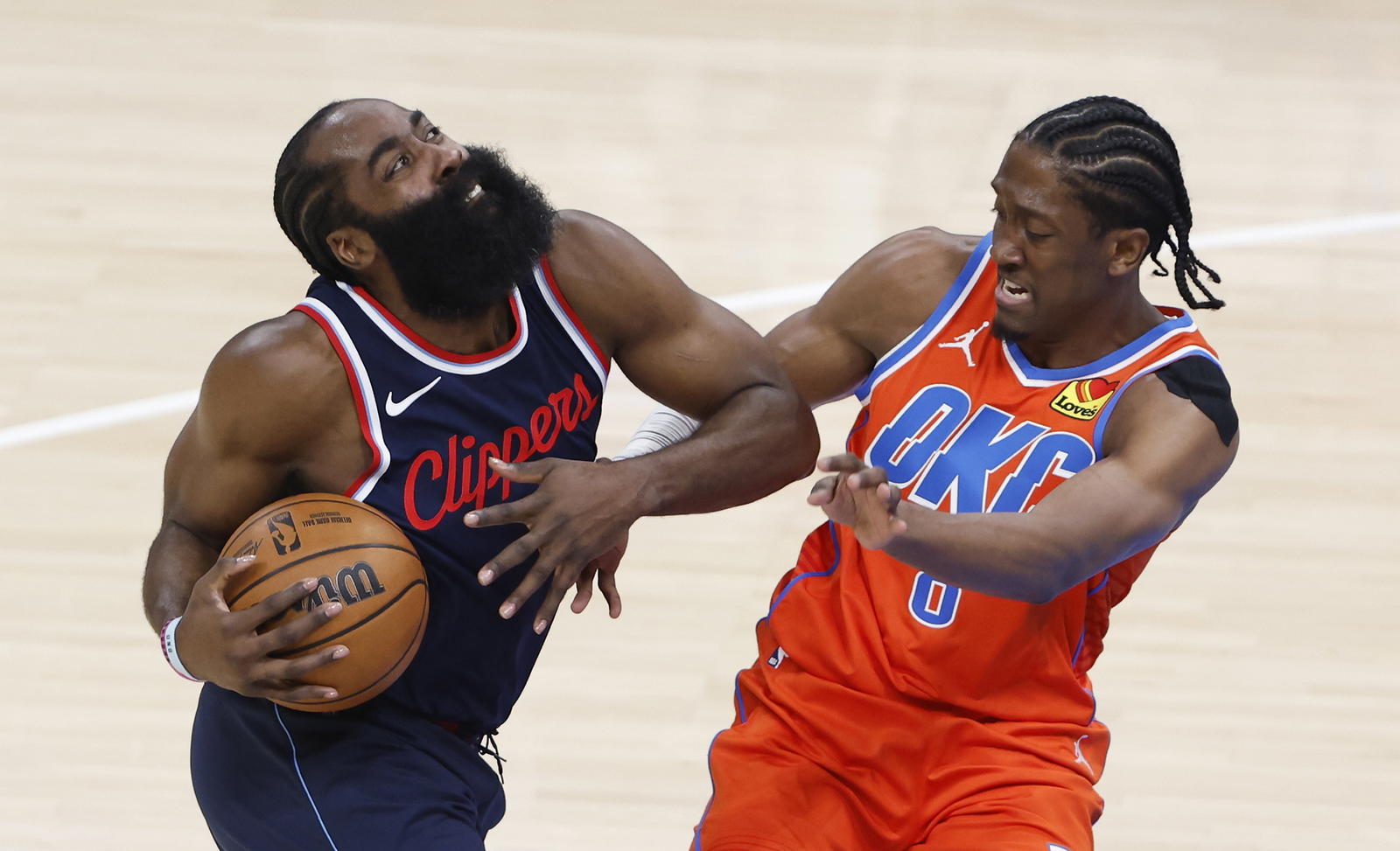 Los Angeles Clippers guard James Harden (1) drives to the basket against Oklahoma City Thunder forward Jalen Williams (8) during the first quarter at Paycom Center. Alonzo Adams-Imagn Images