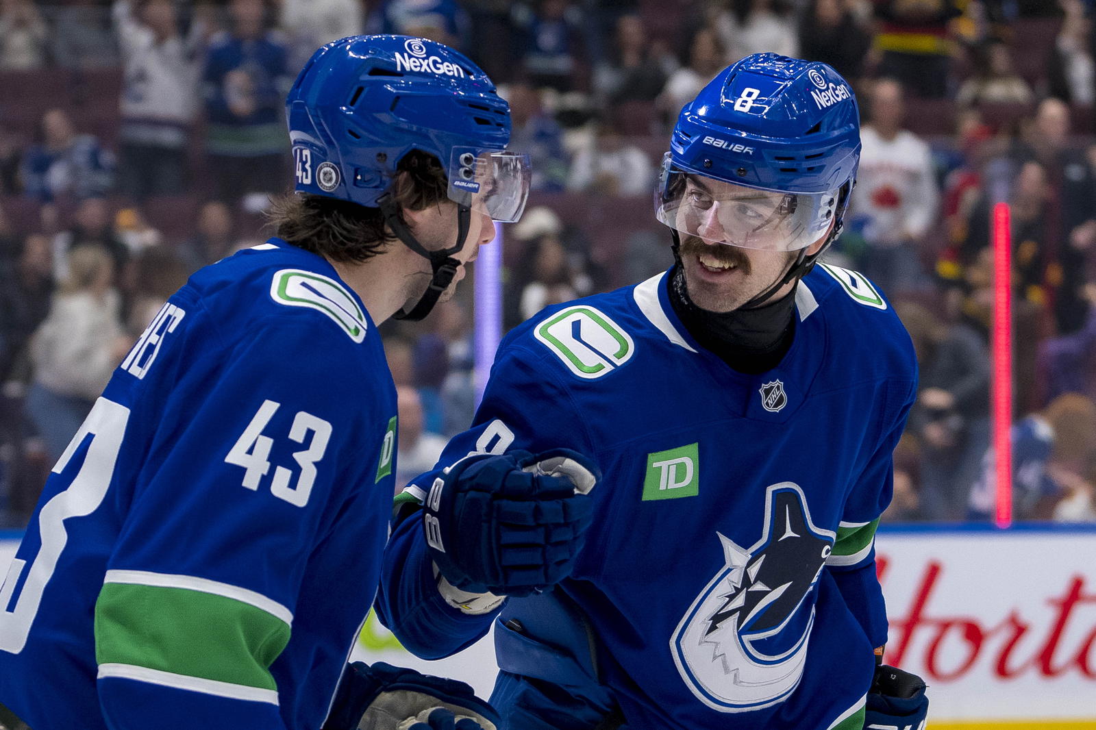 Nov 12, 2024; Vancouver, British Columbia, CAN; Vancouver Canucks defenseman Quinn Hughes (43) and forward Conor Garland (8) celebrate a goal scored by forward Elias Pettersson (not pictured) against the Calgary Flames during the second period at Rogers Arena. Mandatory Credit: Bob Frid-Imagn Images
