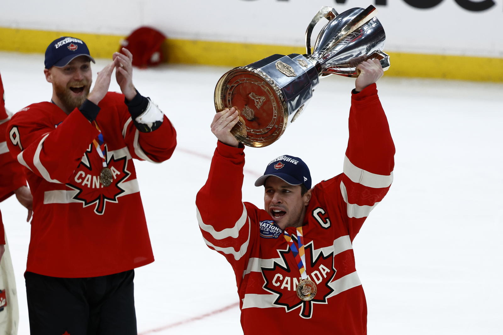 Feb 20, 2025; Boston, MA, USA; [Imagn Images direct customers only] Team Canada forward Sidney Crosby (87) lifts the 4 Nations Face-Off trophy after winning against Team USA in overtime during the 4 Nations Face-Off ice hockey championship game at TD Garden. Mandatory Credit: Brian Fluharty-Imagn Images
