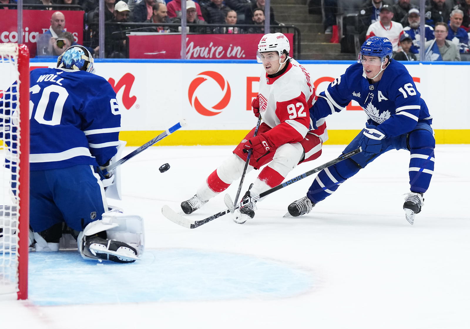 Apr 17, 2025; Toronto, Ontario, CAN; Toronto Maple Leafs right wing Mitch Marner (16) battles for the puck with Detroit Red Wings center Marco Kasper (92) during the second period at Scotiabank Arena. (Nick Turchiaro, Imagn Images)