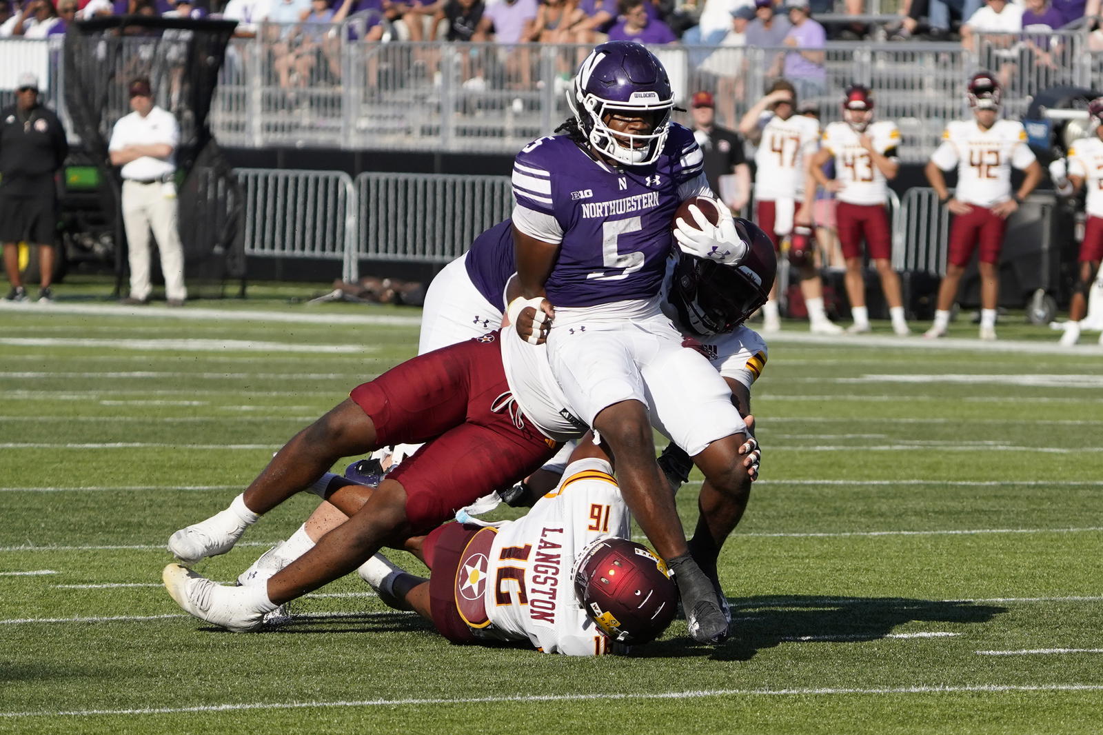 Oct 4, 2025; Evanston, Illinois, USA; ULM Warhawks linebacker Seidrion Langston (16) tries to tackle Northwestern Wildcats running back Caleb Komolafe (5) during the first half at Northwestern Medicine Field at Martin Stadium. Mandatory Credit: David Banks-Imagn Images