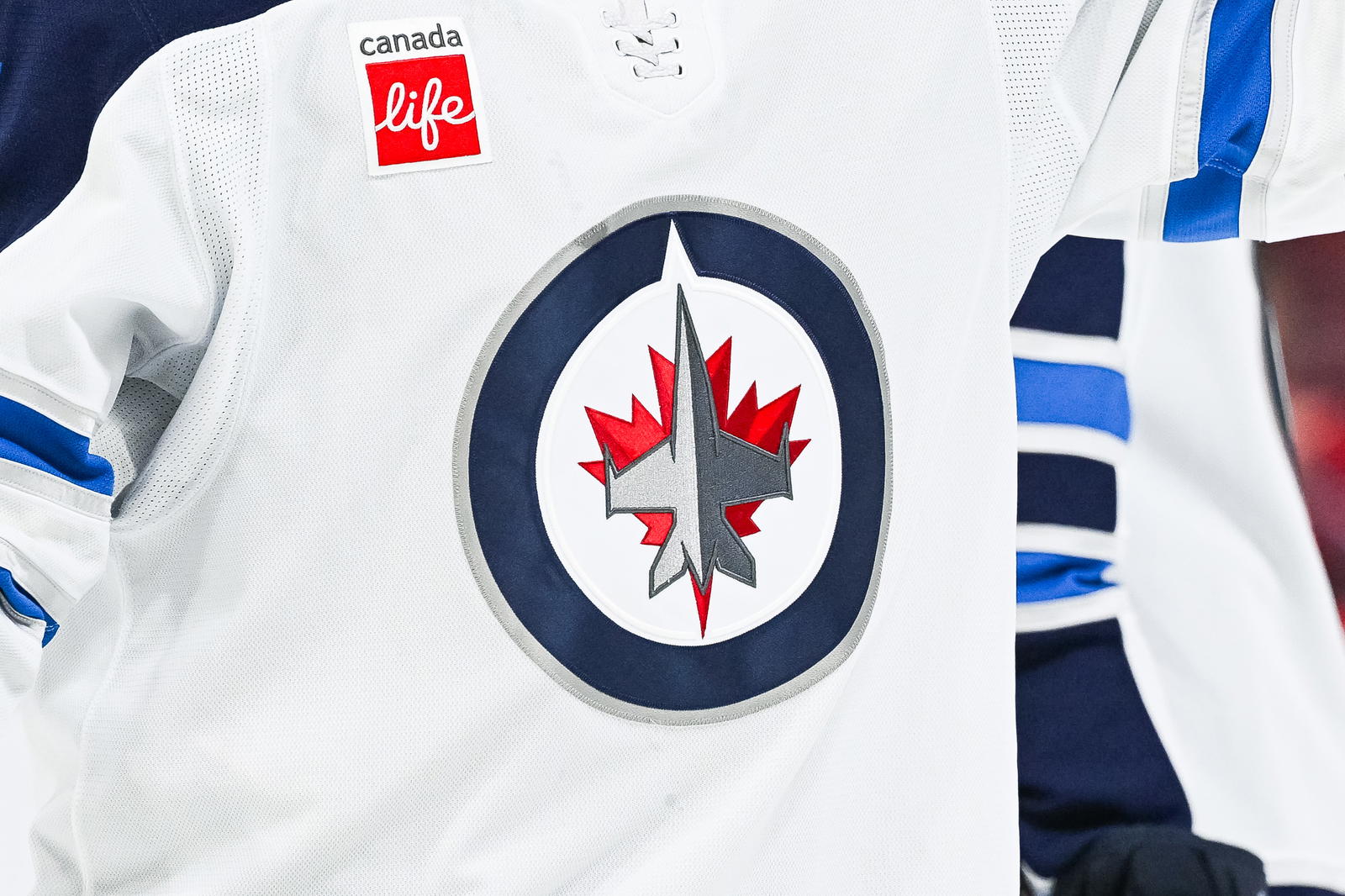 View of a Winnipeg Jets logo on a jersey worn by a member of the team during the second period at Bell Centre. Mandatory Credit: David Kirouac-Imagn Images