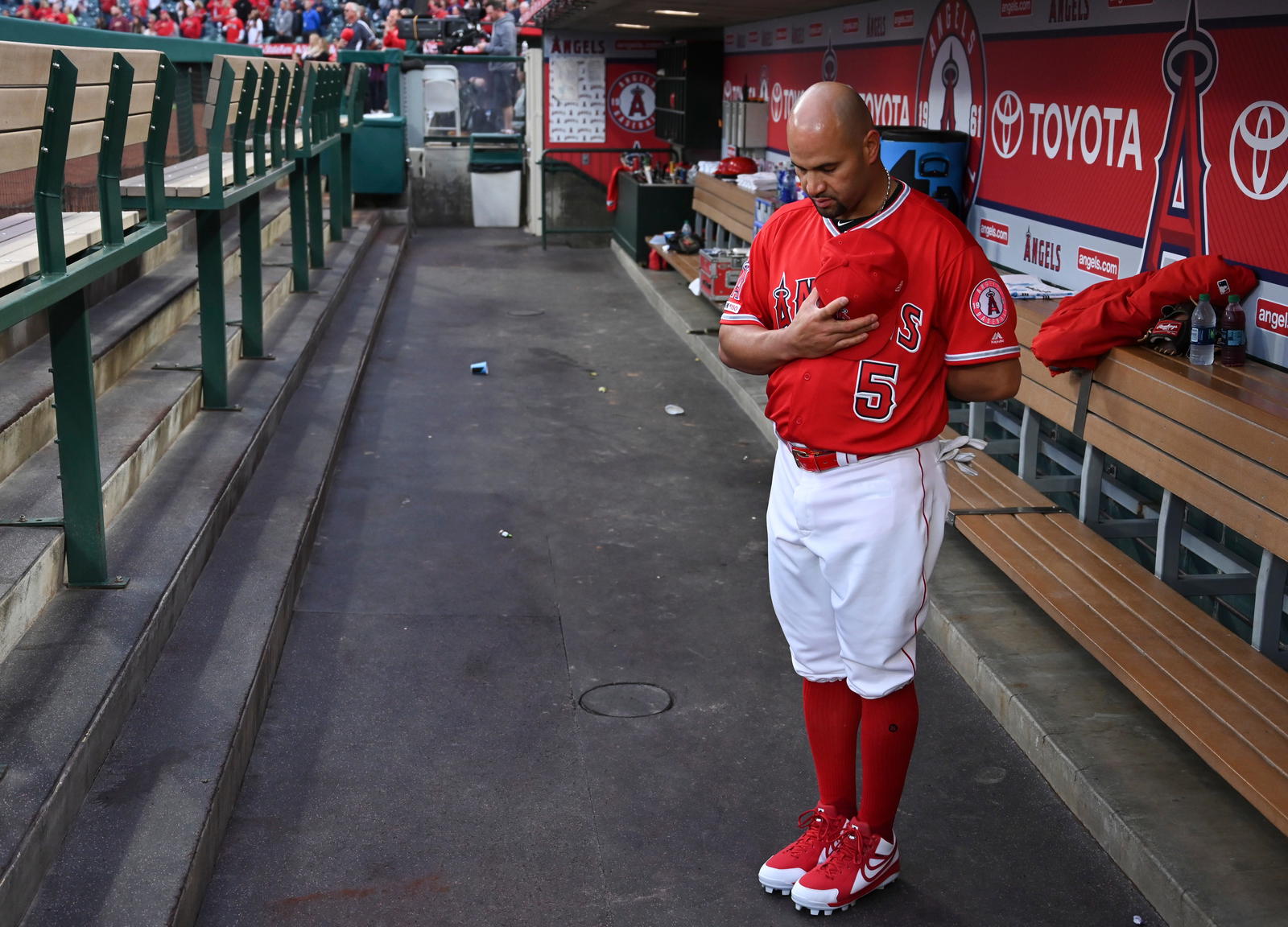 Los Angeles Angels first baseman Albert Pujols in the dugout during the national anthem before the start of a game against the Texas Rangers at Angel Stadium of Anaheim on Apr 5, 2019.&nbsp;Robert Hanashiro / USA TODAY NETWORK via Imagn Images