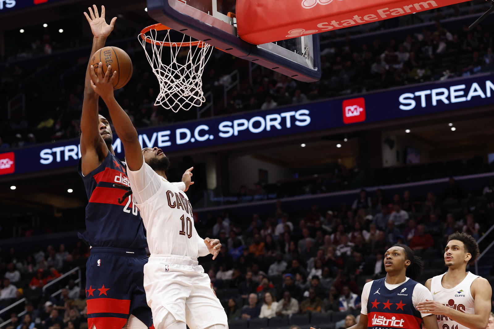 Nov 7, 2025; Washington, District of Columbia, USA; Cleveland Cavaliers guard Darius Garland (10) has a shot blocked by Washington Wizards center Alex Sarr (20) in the second half in an Emirates NBA Cup game at Capital One Arena. Mandatory Credit: Geoff Burke-Imagn Images