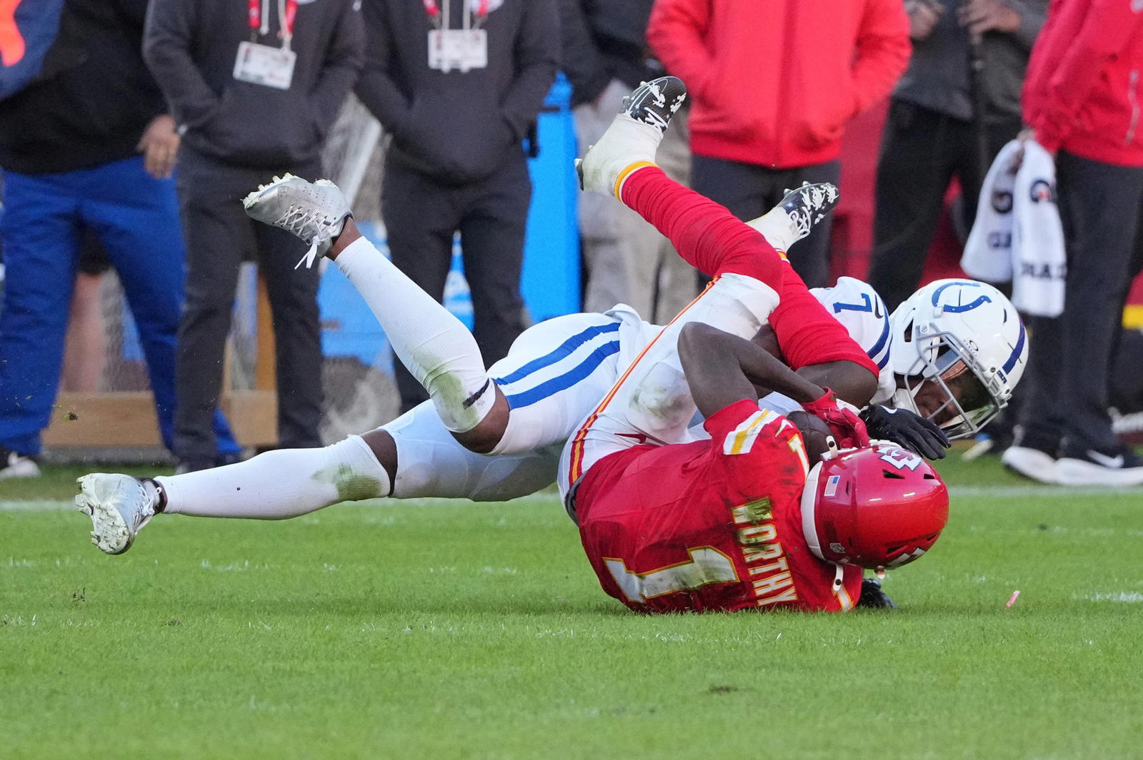 Nov 23, 2025; Kansas City, Missouri, USA; Kansas City Chiefs wide receiver Xavier Worthy (1) makes a catch against Indianapolis Colts cornerback Charvarius Ward (7) in overtime at GEHA Field at Arrowhead Stadium. Mandatory Credit: Denny Medley-Imagn Images