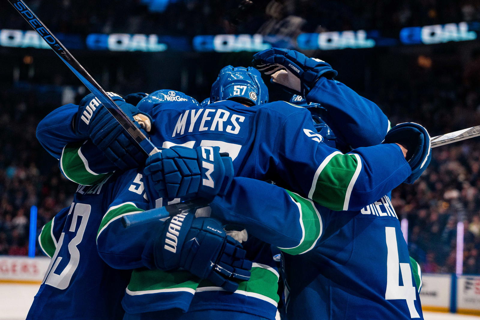 Mar 15, 2025; Vancouver, British Columbia, CAN; Vancouver Canucks forward Teddy Blueger (53) and defenseman Tyler Myers (57) and defenseman Marcus Pettersson (29) and forward Kiefer Sherwood (44) celebrate Myers’ goal against the Chicago Blackhawks in the first period at Rogers Arena. Mandatory Credit: Bob Frid-Imagn Images