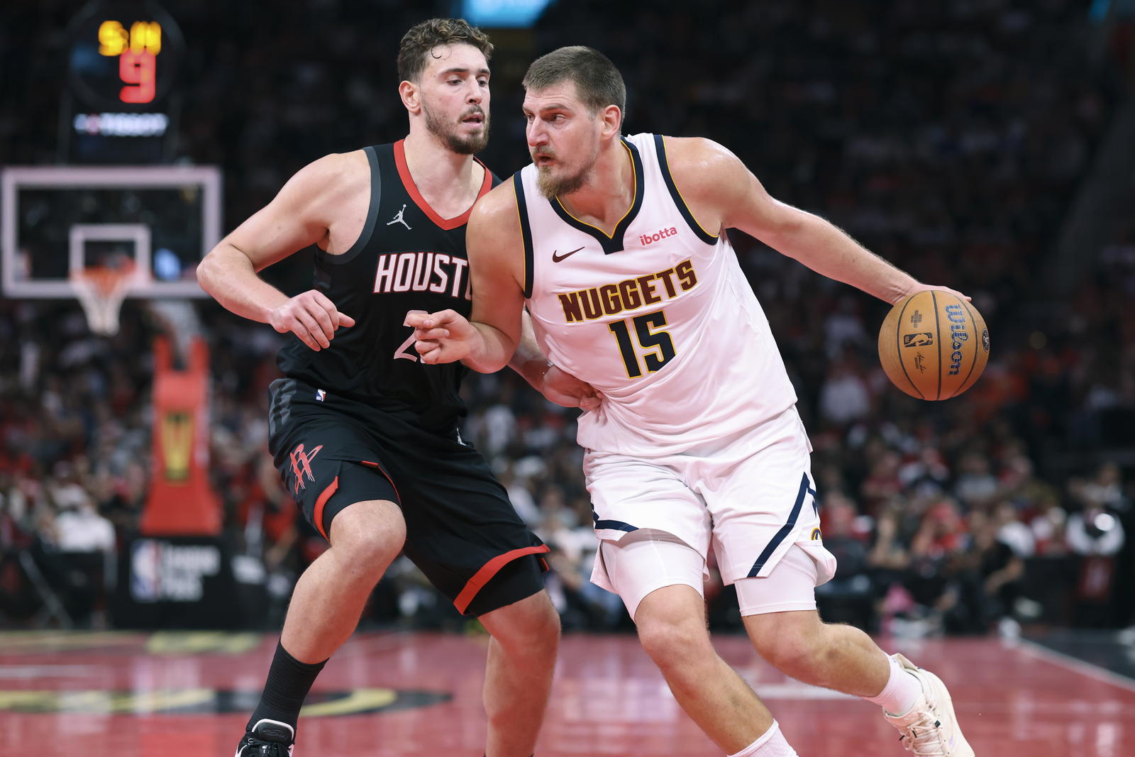Denver Nuggets center Nikola Jokic (15) controls the ball as Houston Rockets center Alperen Sengun (28) defends during the fourth quarter at Toyota Center.&nbsp;Troy Taormina-Imagn Images