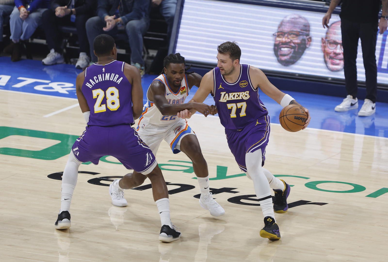 Los Angeles Lakers guard Luka Doncic (77) moves the ball around Oklahoma City Thunder guard Cason Wallace (22) during the first quarter at Paycom Center.&nbsp;Alonzo Adams-Imagn Images