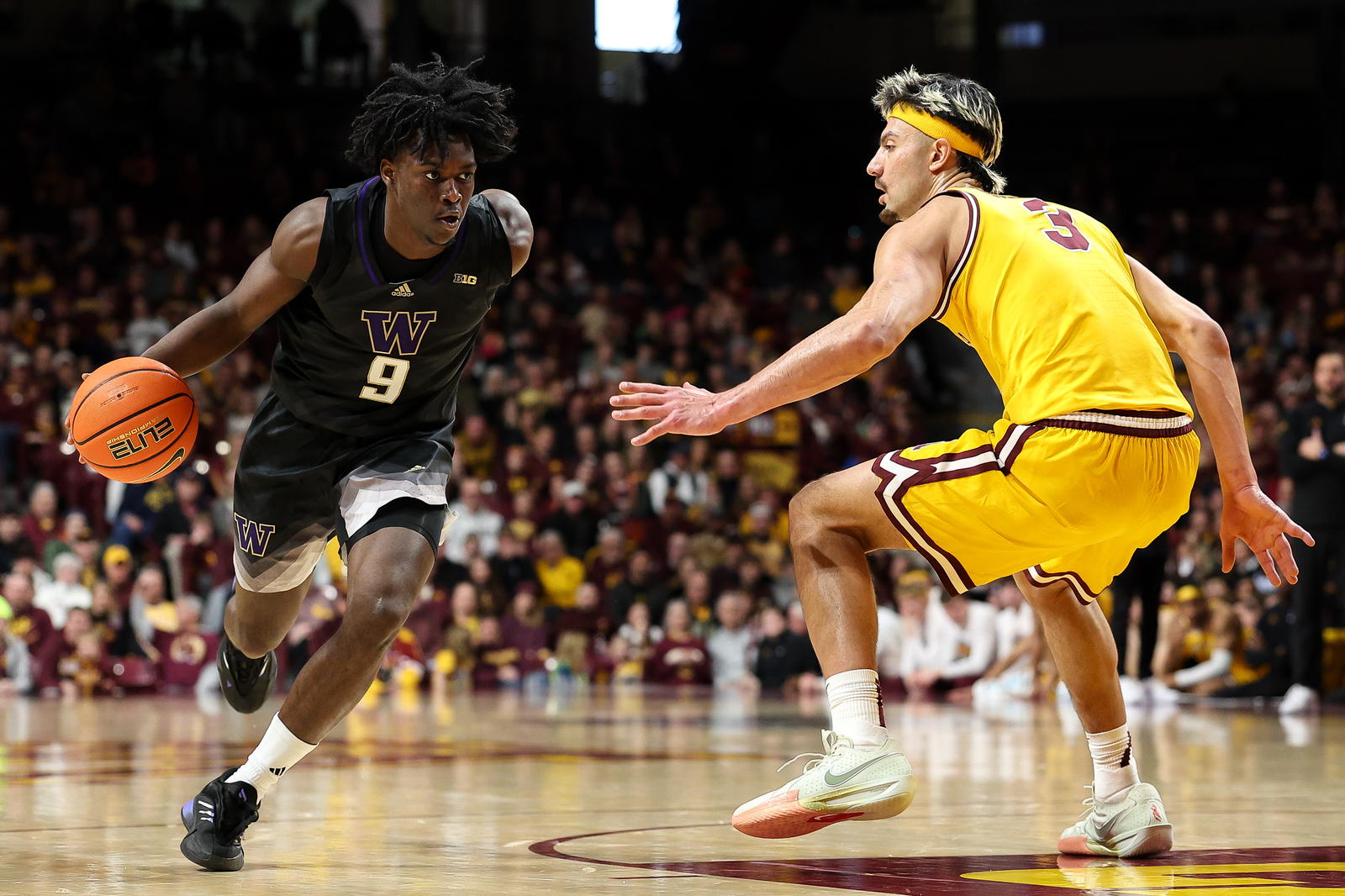 Washington guard Zoom Diallo (9) attempts to dribble around Minnesota forward Dawson Garcia during a game on Feb. 1 at Williams Arena in Minneapolis. - Matt Krohn/Imagn Images.