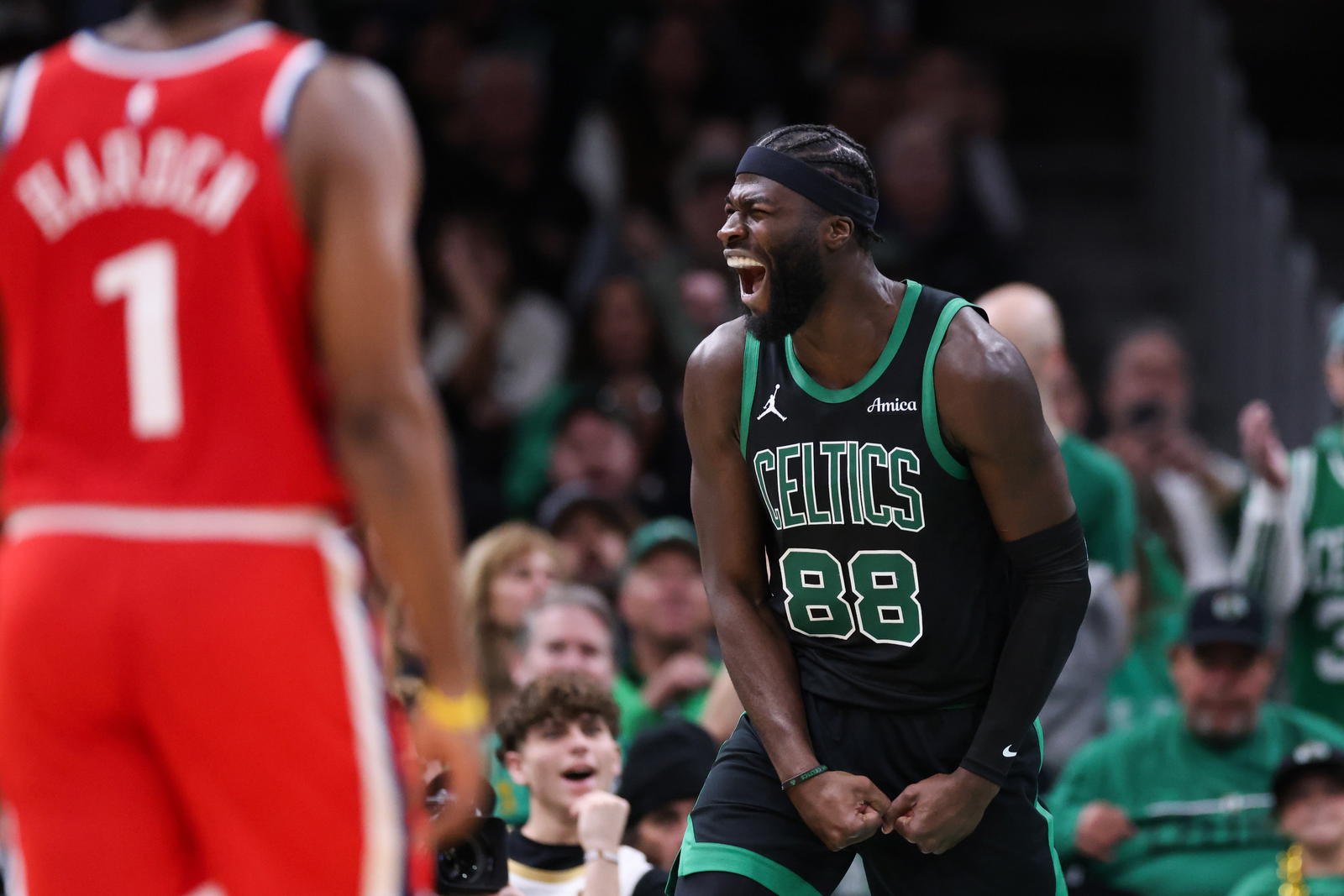 Nov 16, 2025; Boston, Massachusetts, USA; Boston Celtics center Neemias Queta (88) celebrates after a basket during the second half against the Los Angeles Clippers at TD Garden. (Paul Rutherford/Imagn Images)