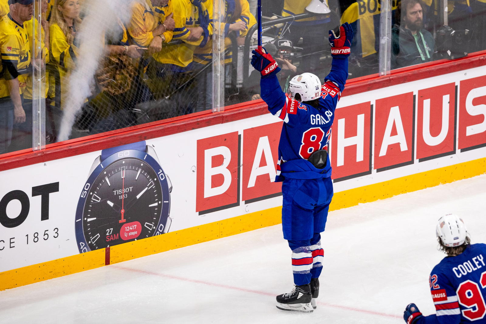 Team USA forward Conor Garland (83) lifts his arms in celebration. (Photo Credit: @USAHockey/X)&nbsp;
