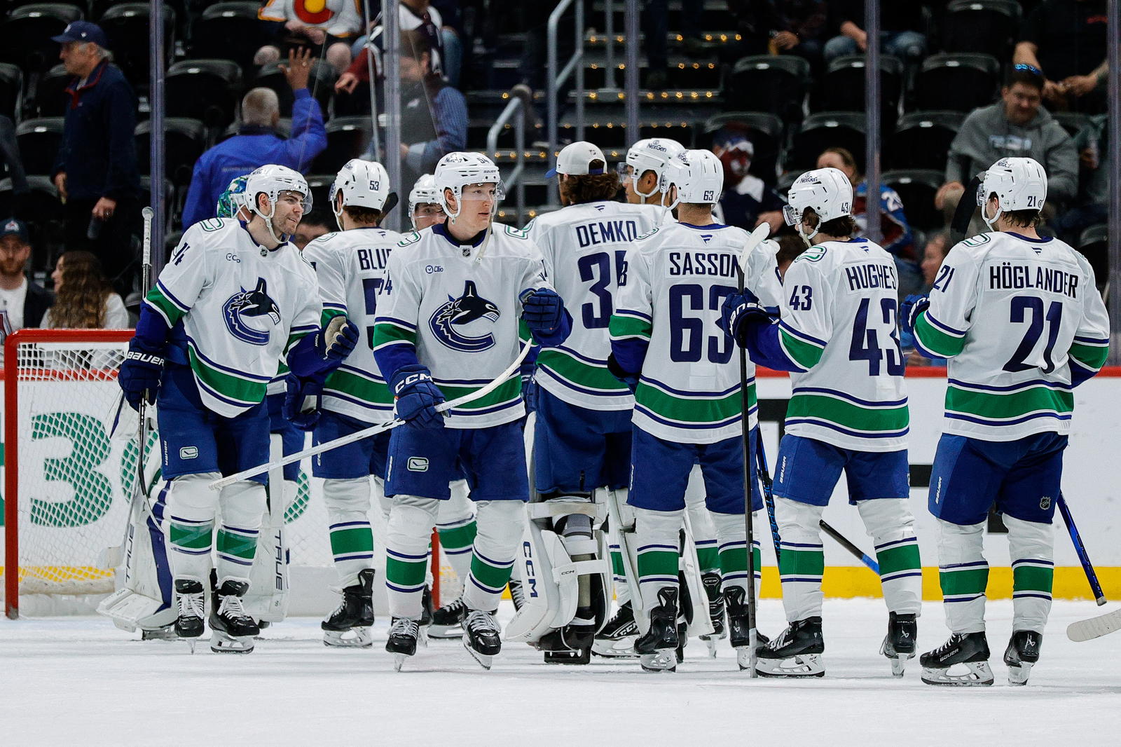 Apr 10, 2025; Denver, Colorado, USA; Vancouver Canucks left wing Jake DeBrusk (74) and center Aatu Raty (54) celebrate with teammates after the game against the Colorado Avalanche at Ball Arena. Mandatory Credit: Isaiah J. Downing-Imagn Images