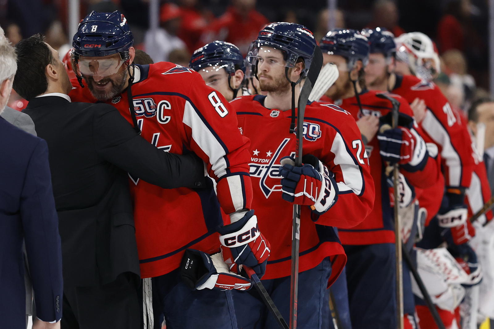 Alex Ovechkin hugs Carolina coach Rod Brind'Amour as Connor McMichael looks on. (Geoff Burke-Imagn Images)